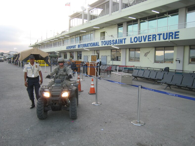 PORT-AU-PRINCE, Haiti -- Captain Kevin O’Byrne, 823rd Expeditionary Security Forces Squadron commander, works with a member of the Haitian National Police to provide security on the flightline at the Toussaint L'Ouverture International Airport here in early February. Although their tour will soon be over, the squadron’s members are still helping to secure all incoming military flights. (Contributed photo/RELEASED)