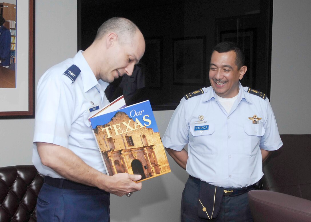 Col. Howard Jones III presents El Salvadoran air force Brig. Gen. Jaime Parada with a memento May 11, 2010, during his two-day visit to Lackland Air Force Base, Texas. Colonel Jones III is the commandant of the Defense Language Institute English Language Center. General Parada is the El Salvadoran vice chief of the Joint General Staff. (U.S. Air Force photo/Alan Boedeker)