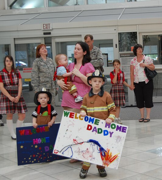 WRIGHT-PATTERSON AIR FORCE BASE, Ohio – Tech. Sgt. Joseph Heitzenrater, 445th Civil Engineer Squadron, is greeted by family and friends at the Dayton International Airport May 20 after returning from a 120-day deployment to Kirkuk Regional Air Base, Iraq.  Sergeant Heitzenrater was assigned as a fire protection crew chief with the 506th Expeditionary Civil Engineer Squadron. (U.S. Air Force photo/Maj. Cynthia Harris)