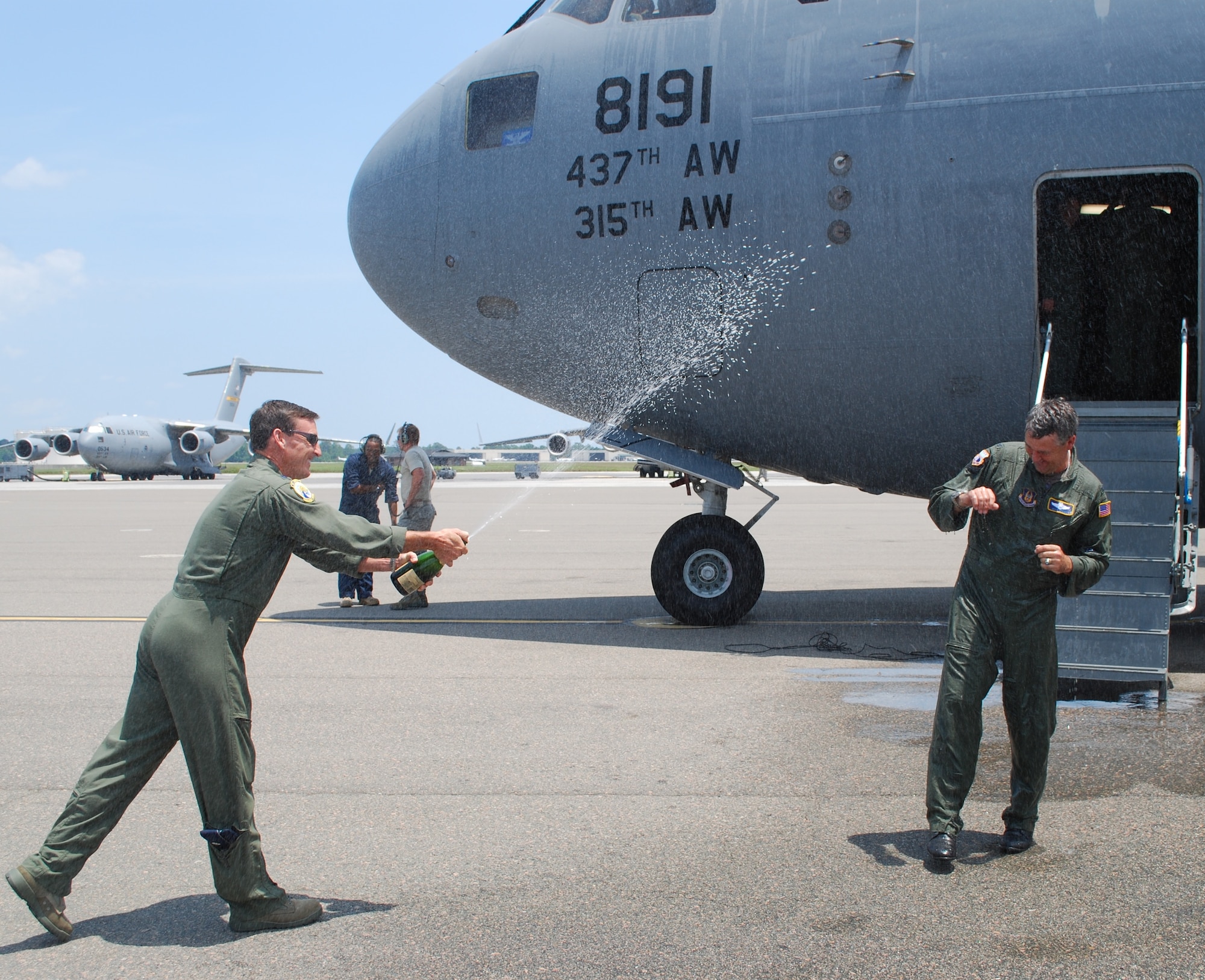 Colonel Mike Speer is sprayed by fellow pilot Lt. Colonel Curt Tucker after his Fini Flight on Friday, May 21st.