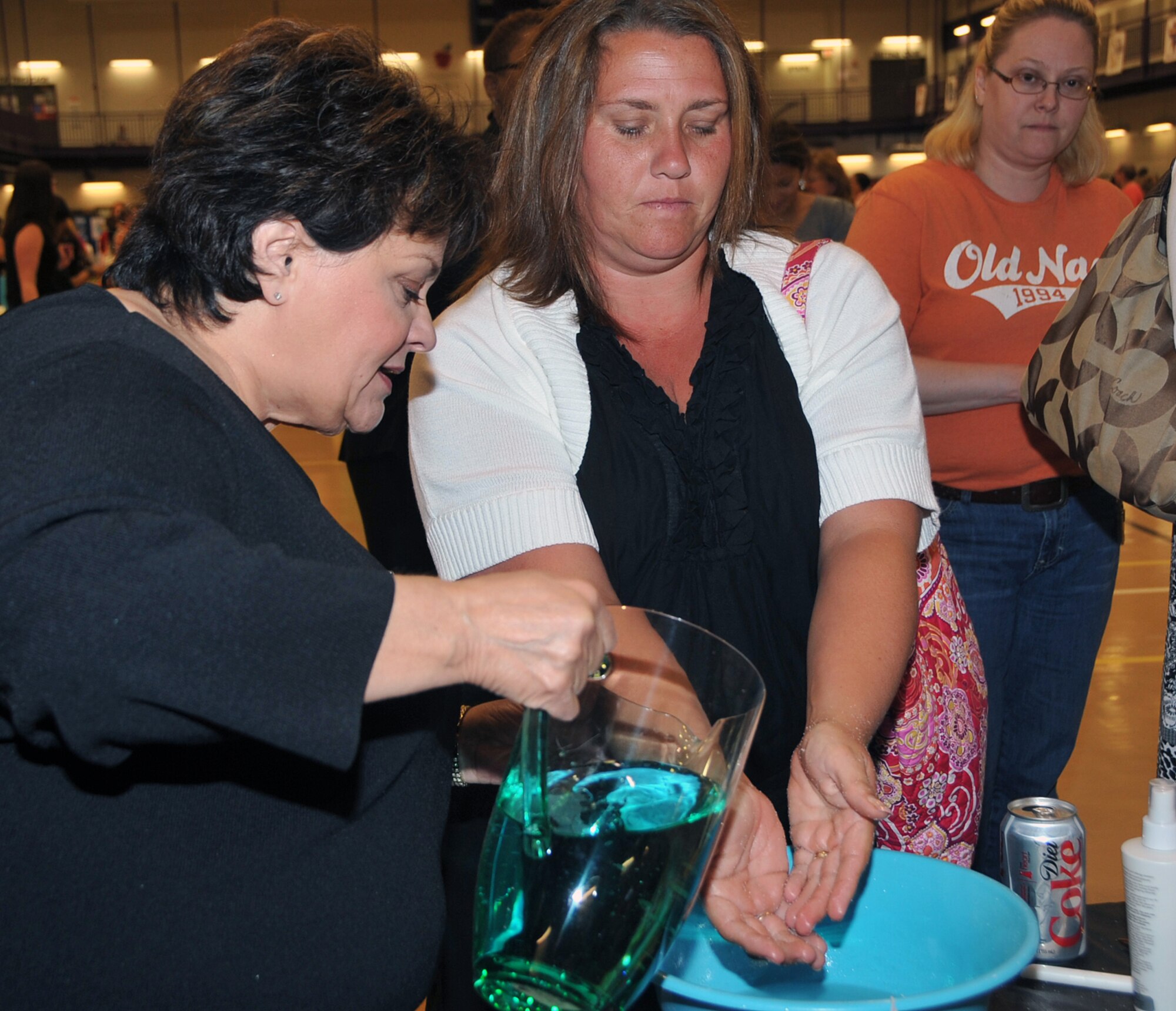 OFFUTT AIR FORCE BASE, Neb. -- Judy Dughman, an independent consultant from BeautiControl, explains the benefits of spa treatments to Tracie Bock, a military spouse, during the Annual Spring Spa for Spouses event at the Lied Activity Center May 19 in Bellevue, Neb. During the event, spouses of military members received free gifts, massages, manicures and dinner. U.S. Air Force Photo by Jeff W. Gates