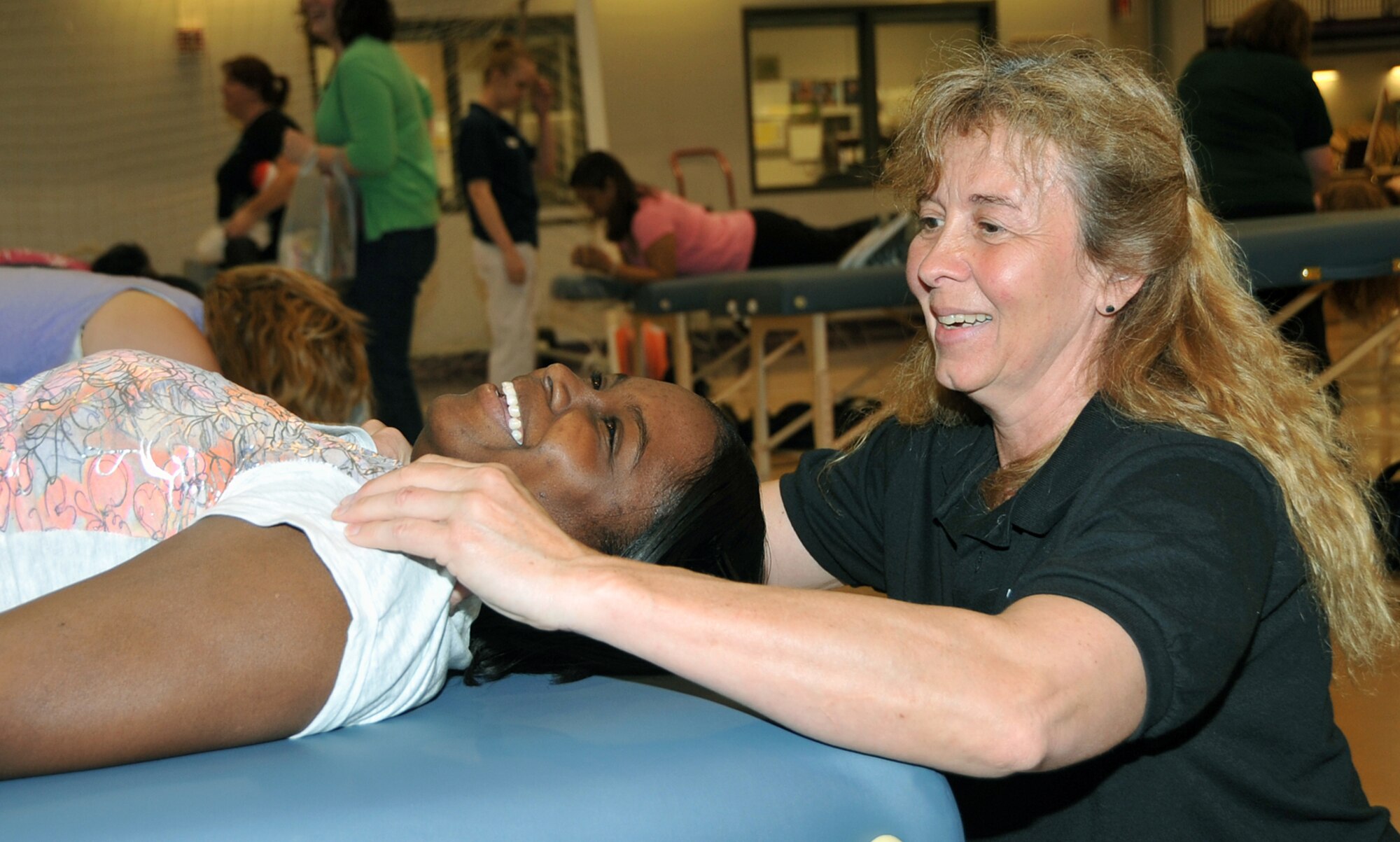 OFFUTT AIR FORCE BASE, Neb. -- Staff Sgt. Chrisma Cruz, 55th Maintenance Group, receives a massage from Teresa, a massage therapist from the Omaha School of Massage and Health Care during the Annual Spring Spa for Spouses event at the Lied Activity Center May 19 in Bellevue, Neb. During the event, spouses of military members received free gifts, massages, manicures and dinner. U.S. Air Force Photo by Jeff W. Gates
