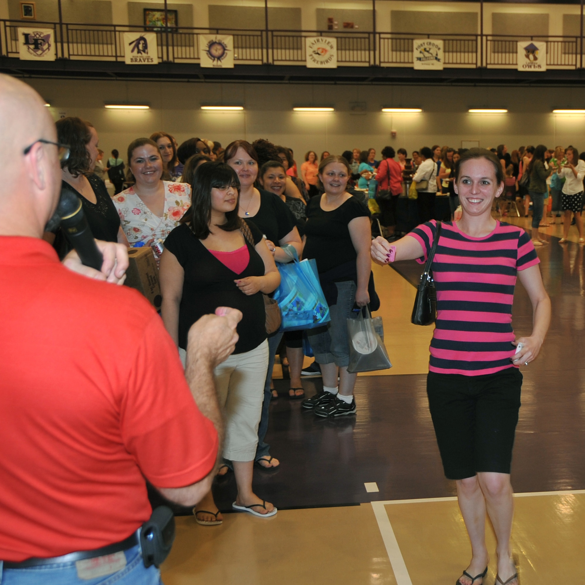 OFFUTT AIR FORCE BASE, Neb. -- Andrea Newcomb, spouse of Staff Sgt. Brad Newcomb from the 97th Intelligence Squadron, shows her winning raffle ticket during the Annual Spring Spa for Spouses event at the Lied Activity Center in Bellevue, Neb., May 19. Mrs. Newcomb won a free 4-hour massage from the Omaha School of Massage and Healthcare. During the event, spouses of military members received free gifts, massages, manicures and dinner. U.S. Air Force Photo by Jeff W. Gates