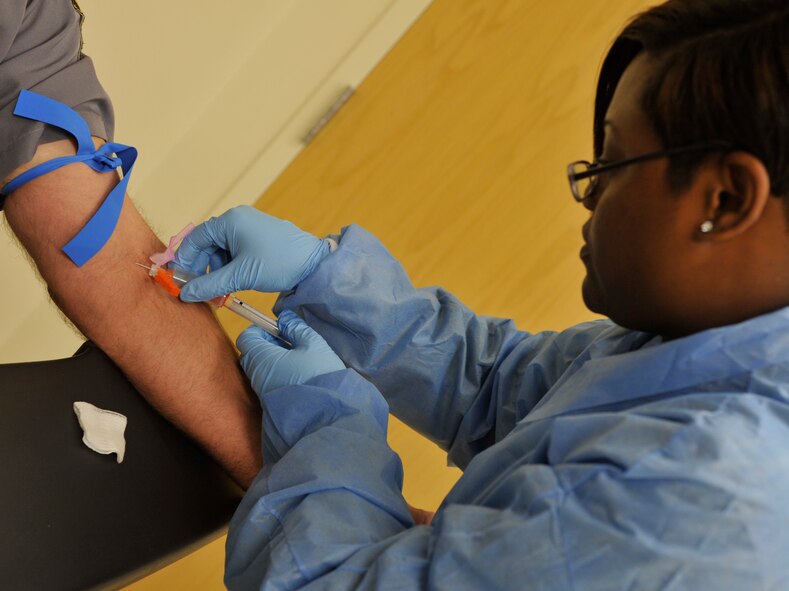 MOODY AIR FORCE BASE, Ga. -- Tech. Sgt. Monica Johnson, 74th Fighter Squadron independent duty medical technician, draws a patient’s blood here May 10. In deployed locations, IDMTs are sometimes the only individuals available to provide health care , so they need to be to able to complete basic but essential procedures within several medical career fields. (U.S. Air Force photo by Staff Sgt. Schelli Jones/RELEASED)