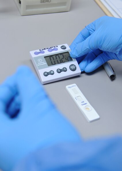 MOODY AIR FORCE BASE, Ga. -- Tech. Sgt. Monica Johnson, 74th Fighter Squadron independent duty medical technician, sets the timer to administer a pregnancy test here May 10. To remain current and proficient in lab procedures, IDMTs are required to complete eight hours of lab training annually. (U.S. Air Force photo by Staff Sgt. Schelli Jones/RELEASED)