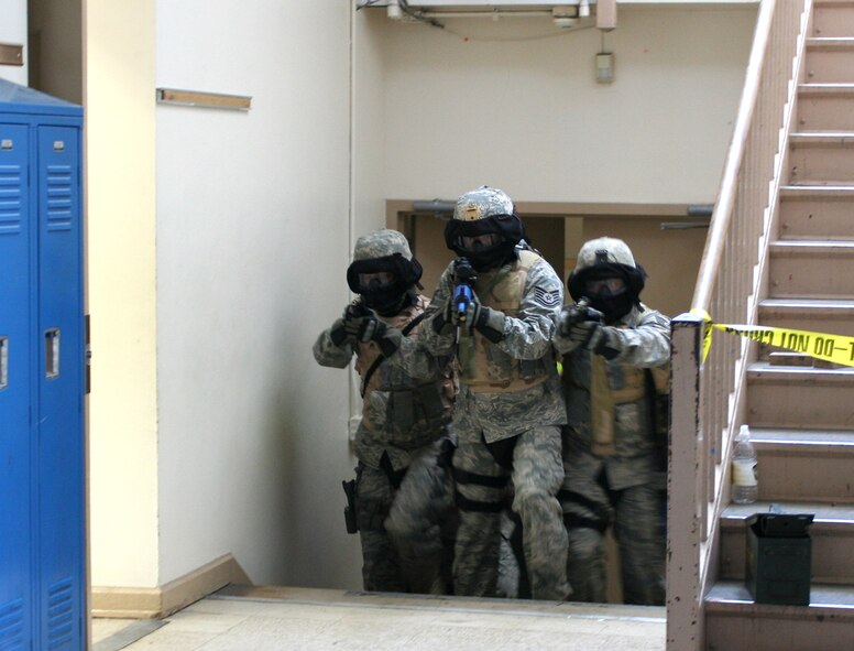 WRIGHT-PATTERSON AIR FORCE BASE, Ohio -- Airmen from the 445th Security Forces Squadron enter a hallway during a simulated crisis situation during Active Shooter Training May 20 in Columbus, Ohio.  The Active Shooter Training Course was taught by the Ohio State Highway Patrol Special Response Team, which has provided similar training to more than 6,000 law enforcement and peace officers throughout the state, including Airmen from the 88th Security Forces Squadron.  It was the first time Airmen from the 445th Airlift Wing attended the training.  (U.S. Air Force photo/Capt. Caroline Wellman)