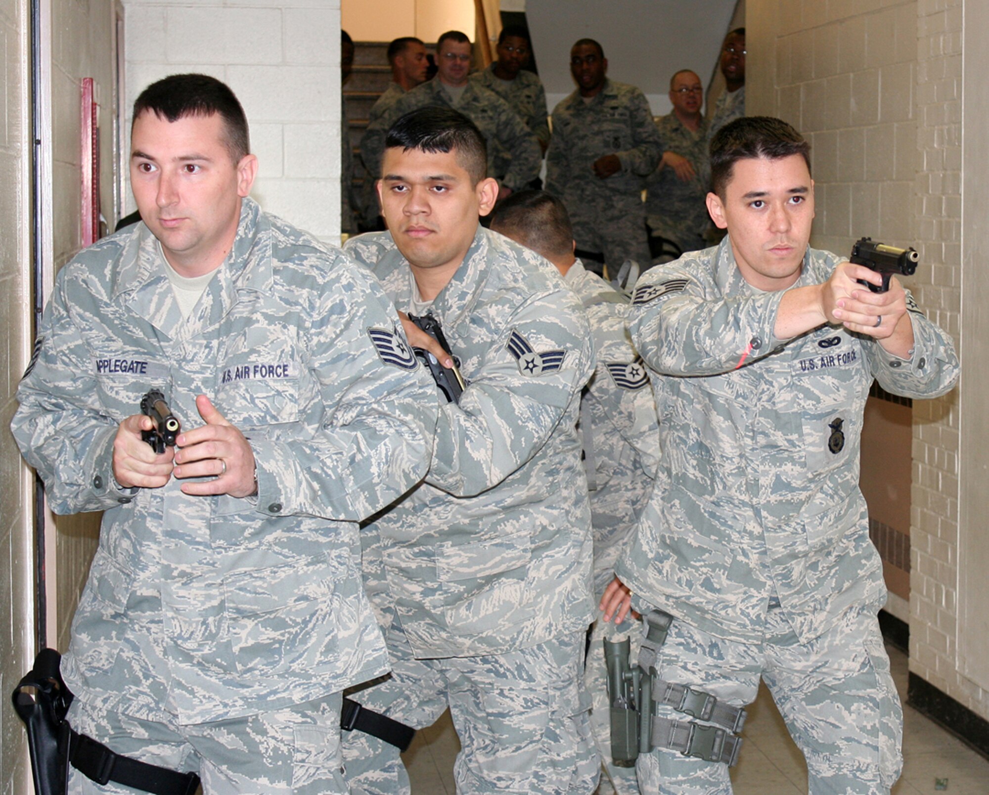 WRIGHT-PATTERSON AIR FORCE BASE, Ohio -- Tech. Sgt. Jarrod Applegate, Staff Sgt. Zach Johnson, and Senior Airman Gustavo Medina, 445th Security Forces Squadron, practice securing a hallway during Active Shooter Training May 20 in Columbus, Ohio. The Ohio State Highway Patrol Special Response Team has provided training to the 88th Security Forces Squadron for two years.  This is the first time Airmen from the 445th Airlift Wing attended the training.  (U.S. Air Force photo/Capt. Caroline Wellman)