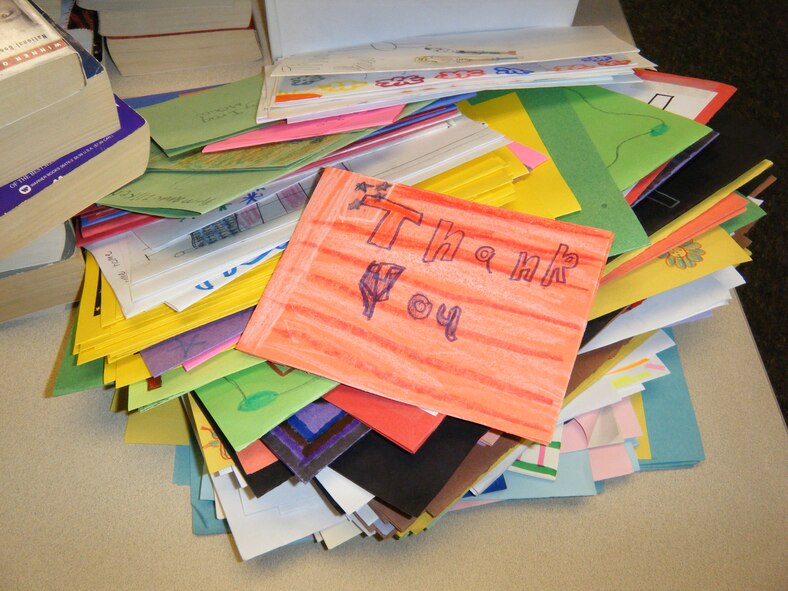 HOLLOMAN AIR FORCE BASE, N.M. -- Hand-made thank-you cards from children of Holloman schools sit on a table, May 11, 2010, before being packed away in care packages for deployed troops in a project called Operation Care Package. The care packages also contained cookies, beef jerky, hand sanitizer, foot powder, puzzle books and thank-you letters from New Mexico Congressmen, all in an effort to show appreciation for Team Holloman members who are deployed. (Courtesy photo / Released)