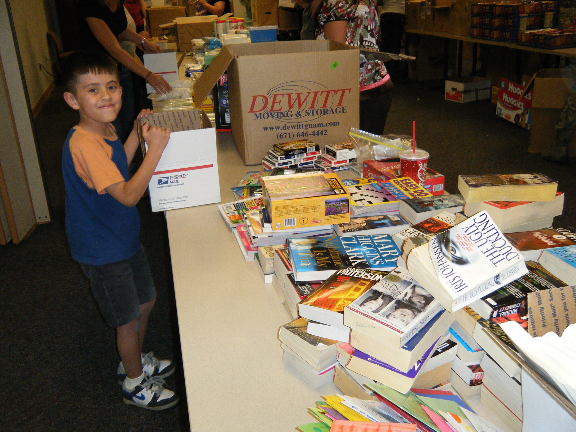 HOLLOMAN AIR FORCE BASE, N.M. -- Miguel Lopez, 9, son of Tech. Sgt. Miguel Lopez-Castaneda, 49th Logistics Readiness Squadron, helps package items into boxes to be sent to deployed troops during Operation Care Package May 11, 2010. More than 50 volunteers came out to pack 385 care packages for Team Holloman men and women who are currently deployed. (Courtesy photo / Released) 