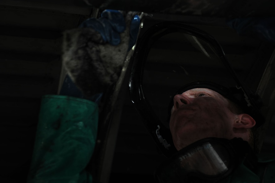 MOODY AIR FORCE BASE, Ga. -- Airman 1st Class Cody Scherer, 23rd Equipment Maintenance Squadron aerospace propulsion apprentice, wipes down the flap track underneath a HC-130P Combat King here May 17. It takes 12 Airmen a full 12-hour shift beginning at 6 a.m. to clean the C-130. (U.S. Air Force photo by Airman 1st Class Joshua Green/RELEASED)