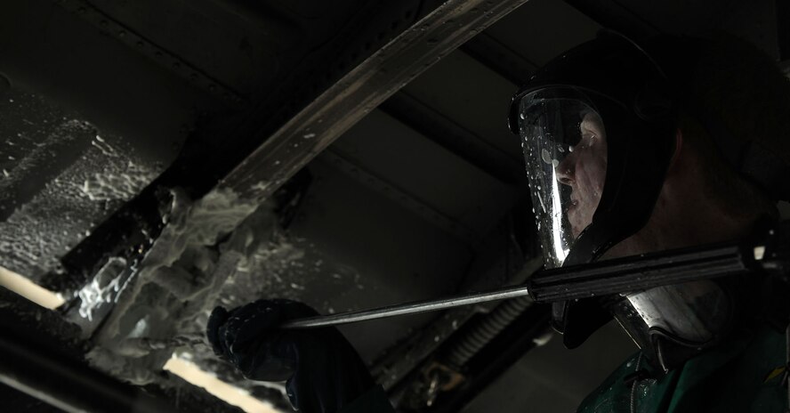 MOODY AIR FORCE BASE, Ga. -- Airman 1st Class Cody Scherer, 23rd Equipment Maintenance Squadron aerospace propulsion apprentice, sprays a cleaning liquid onto the flap track underneath a HC-130P Combat King here May 17. Each C-130 is cleaned every 180 days and so approximately one to two are washed each month. (U.S. Air Force photo by Airman 1st Class Joshua Green/RELEASED)