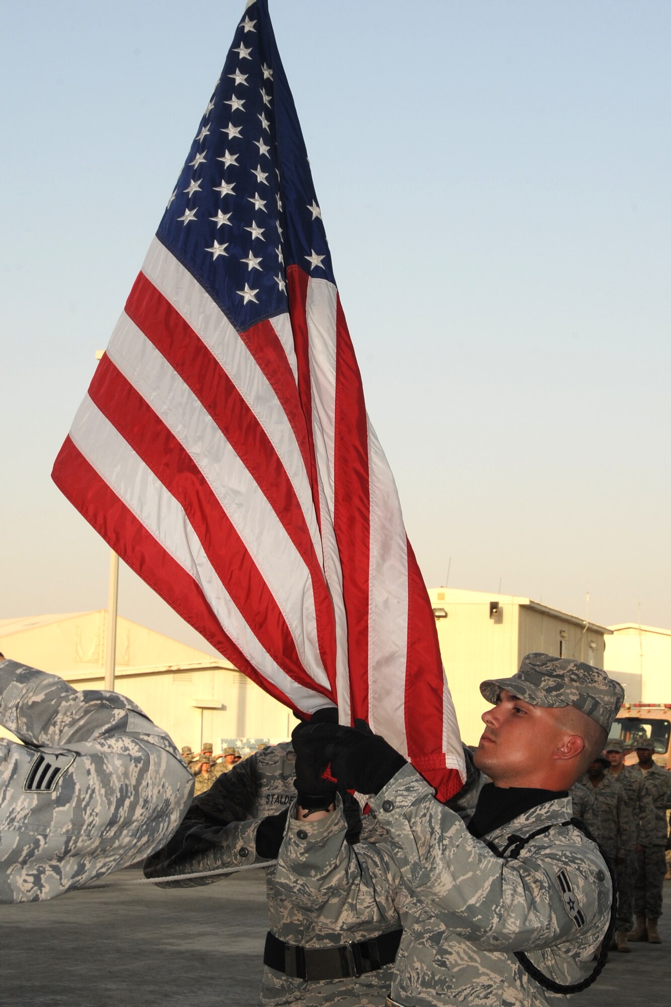 Airmen participate in a retreat ceremony May 21, 2010, at a non-disclosed base in Southwest Asia. The 380th Air Expeditionary Wing staff served as the lead unit in formation for the ceremony. Every week, the 380th AEW holds a retreat ceremony to honor the American flag and what it stands for. The 380th AEW supports operations Iraqi Freedom and Enduring Freedom and the Combined Joint Task Force-Horn of Africa.(U.S. Air Force photo/Senior Airman Jenifer H. Calhoun)
