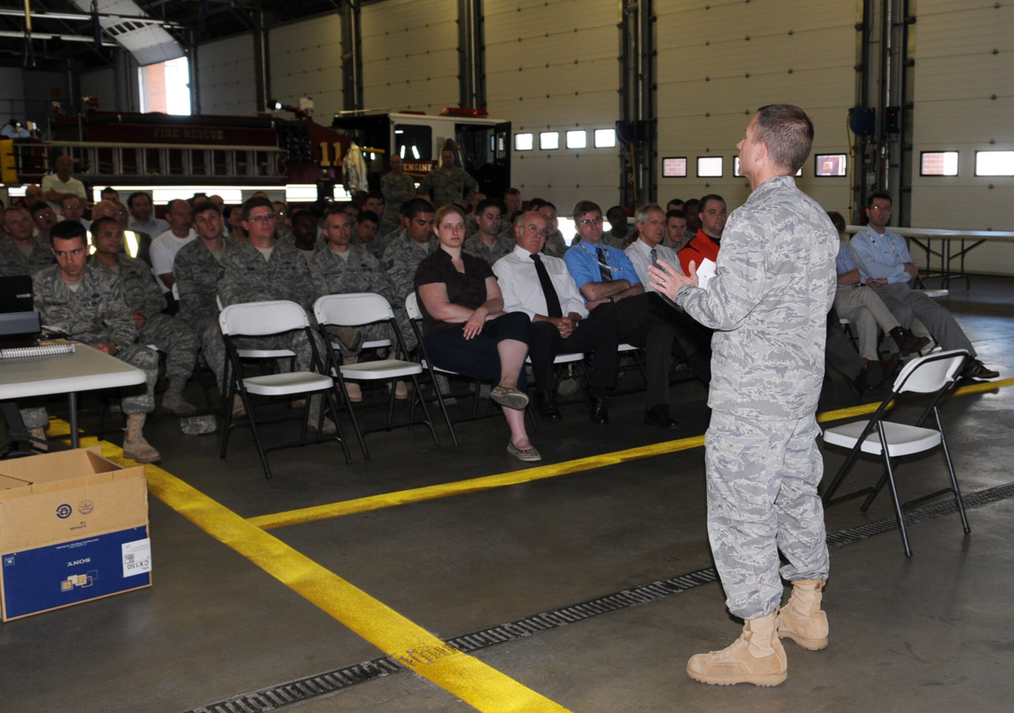 Both civilian and military members from the 100th Civil Engineer Squadron take part in a commander's call May 21 at the fire department, as part of the 100th Air Refueling Wing Safety Stand-down event. The 100th CES commander, Lt. Col. Matt Greene, hosted the commander's call, which was followed by a chip pan fire demonstration and a barbecue. Squadrons around the base had briefings and demonstrations covering different aspects of safety, including suicide prevention awareness, wing man concept and motor vehicle safety. (U.S. Air Force photo/Karen Abeyasekere)
