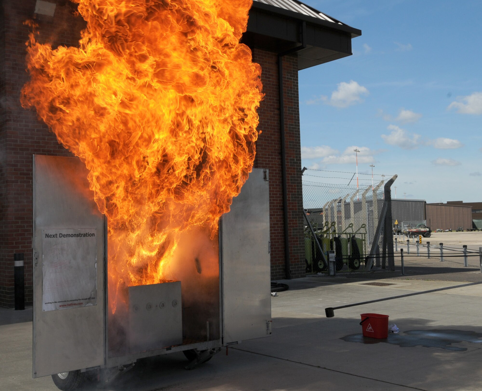 The 100th Civil Engineer Squadron Fire Department performed a chip pan/grease fire demonstration May 21 at the 100th CES's portion of the 100th Air Refueling Wing Safety Stand-down event. The demonstration showed the effects of pouring water on a grease pan fire, rather than putting it out safely. If a chip pan/grease pan catches fire, cover it in a damp, wrung-out towel or dry fire blanket, then call the fire department (911 if on base, or 999 if off base). The Air Force Chief of Staff, Gen. Norton Schwartz, identified May as an opportunity to reemphasize the importance of the wingman concept among our Airmen, and to address a recent rise in Air Force suicides and motor vehicle mishaps. (U.S. Air Force photo/Karen Abeyasekere)
