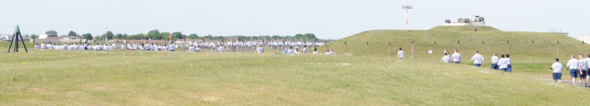 A line of hundreds of Team Mildenhall Airmen snakes its way around the perimeter road May 21 during the monthly 5K fun run. Spouses, children and dogs also took part in the event, held to promote health and fitness. (U.S. Air Force photo/Karen Abeyasekere)