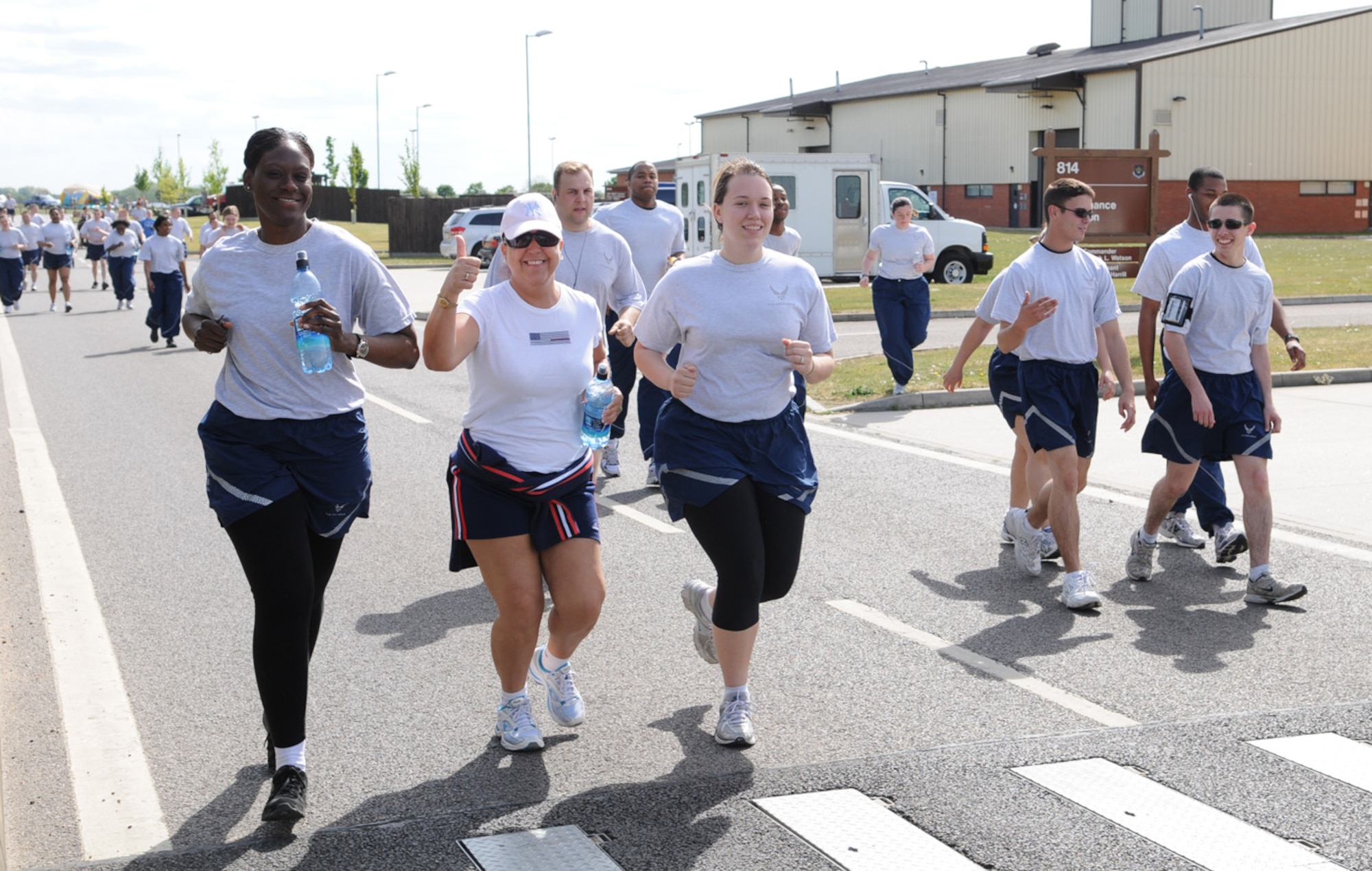 Team Mildenhall members are all smiles as they take part in the 5K fun run May 21, held monthly near the Hardstand Fitness Center. (U.S. Air Force photo/Karen Abeyasekere)