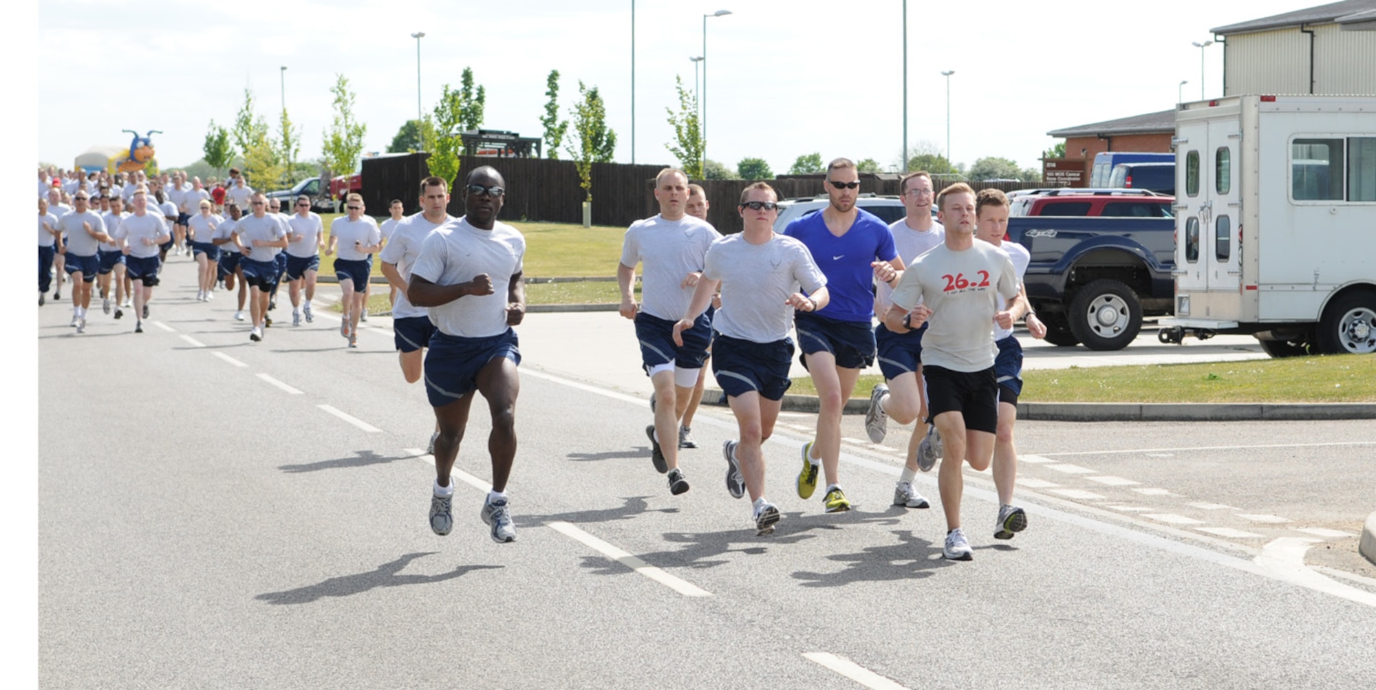 The front runners lead the way in Team Mildenhall's monthly 5K fun run May 21 near the Hardstand Fitness Center. Hundreds of Airmen participated in the event, which also included spouses, children and dogs, held monthly to promote health and fitness. (U.S. Air Force photo/Karen Abeyasekere)