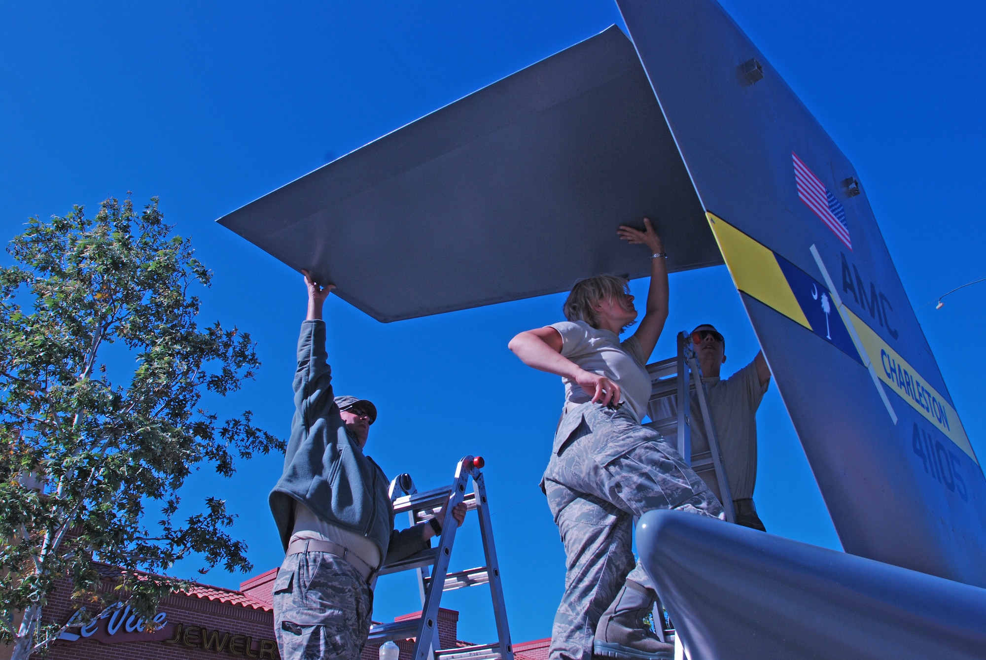 Reservists from the 315th Airlift Wing, Charleston Air Force Base S.C.Tech Sergeants Beth Holzbaur and Tony Galioto and Staff Sergeant Shawn Summers assemble the Mini C-17 at Riverside Plaza in Riverside Calif April 29. The Mini C-17 is a community outreach tool of the 315th Airlfit Wing that travels the country educating the public on the C-17 and the Air Force Reserve. (U.S. Air Force Photo)
