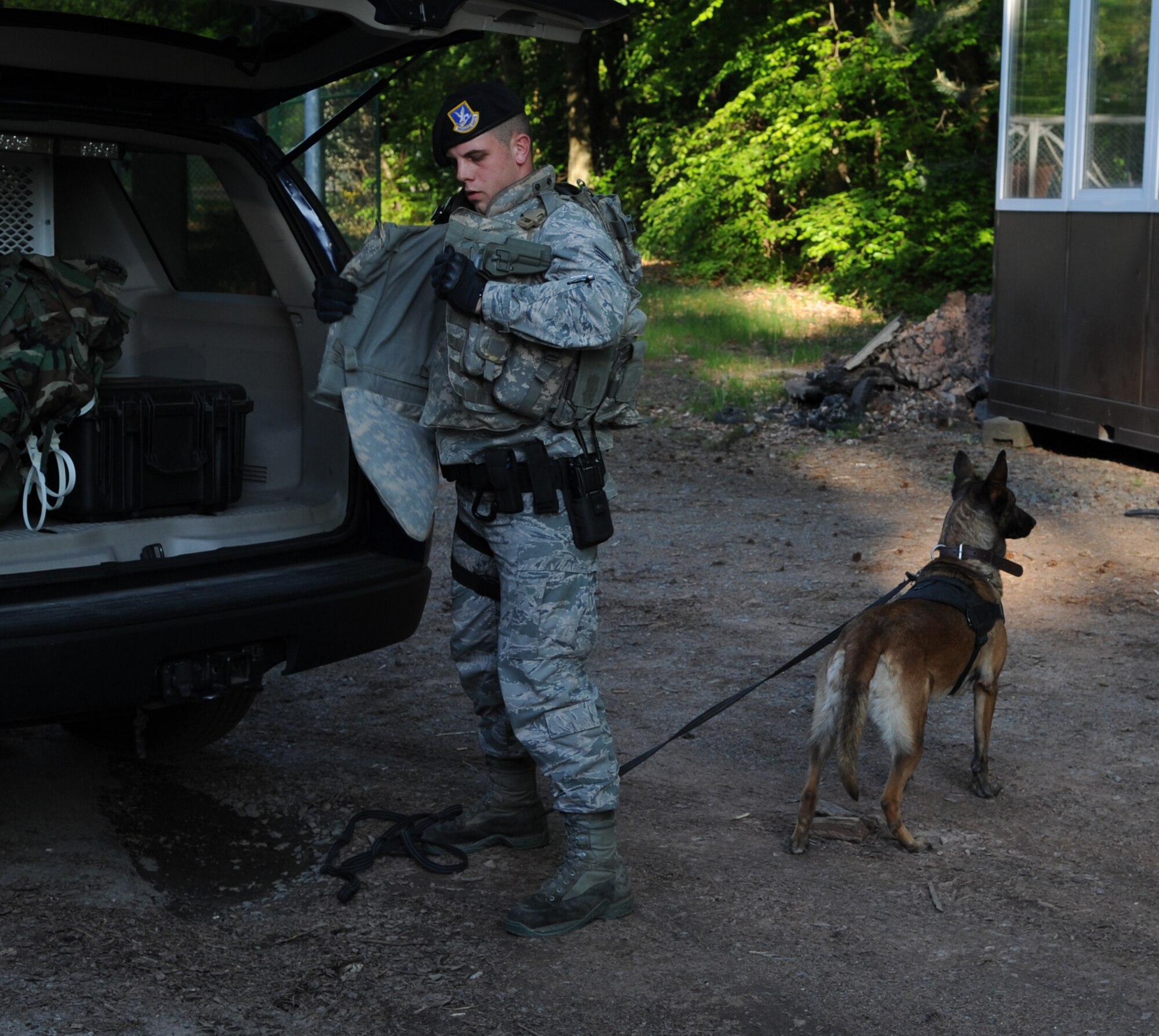 U.S. Air Force Staff Sgt. Daren Marshall, 86th Security Forces Squadron K-9 handler, and Olivia, military working dog, prepare a search for base runners during an Operational Readiness Exercise (ORE), Ramstein Air Base, Germany, May 23, 2010. An ORE incorporates a series of events that evaluate a wing's ability to perform accurately in a timely manner. (U.S. Air Force Photo by Airman 1st Class Caleb Pierce)