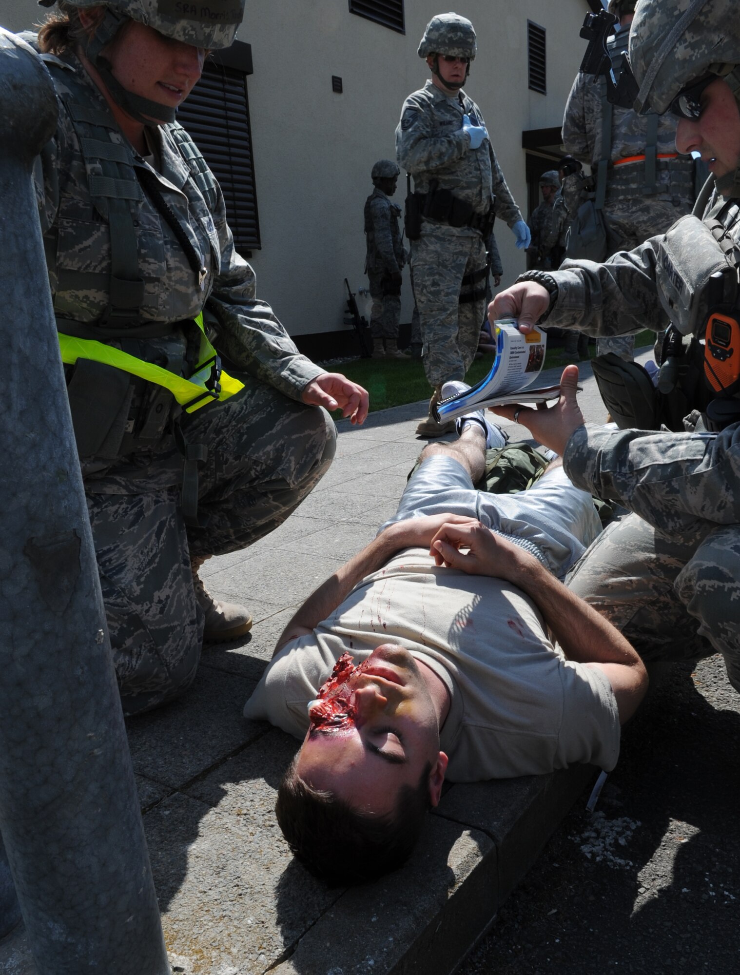 U.S. Air Force 86th Security Forces members demonstrate their Self Aid Buddy Care skills during an Operational Readiness Exercise (ORE), Ramstein Air Base, Germany, May 23, 2010. An ORE incorporates a series of events that evaluate a wing's ability to perform accurately in a timely manner. (U.S. Air Force Photo by Airman 1st Class Caleb Pierce)