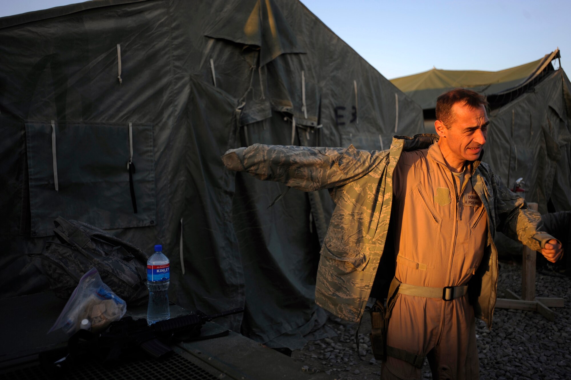 U.S. Air Force Lt. Col. James Duban, an Mi-17 pilot assigned to the 438th Air Expeditionary Advisor Squadron, gets geared up, early in the morning after having to spend the night after a severe sand storm grounded the aircrew May 13, 2010, at Forward Operating Base Sharana, Afghanistan. (U.S. Air Force photo/Staff Sgt. Manuel J. Martinez/released) 