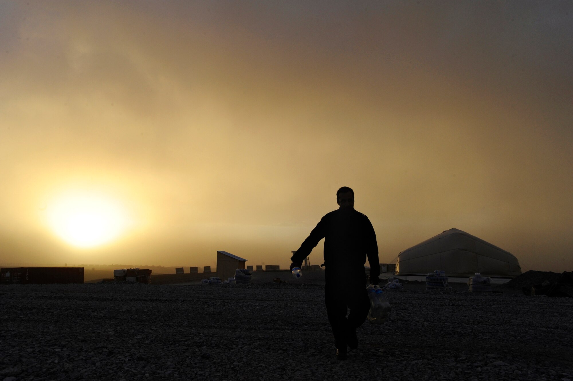 Sergeant Nasir Abdul, an Afghan National Army Air Corps Mi-17 flight engineer, grabs bottled water for the rest of his crew May 12, 2010, at Forward Operating Base Sharana, Afghanistan. (U.S. Air Force photo/Staff Sgt. Manuel J. Martinez/released) 