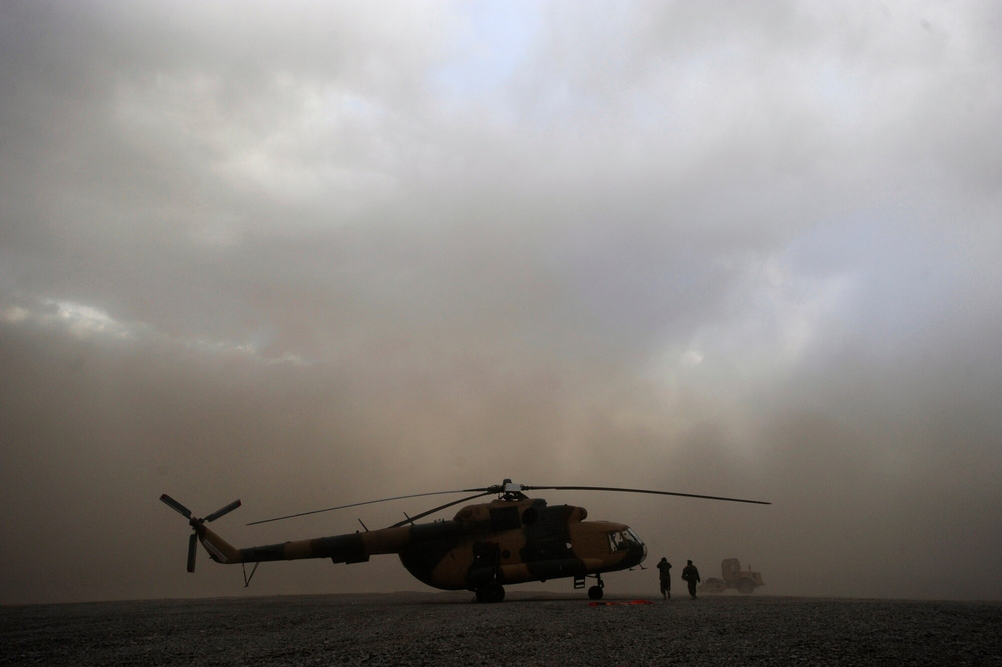 Afghan National Army Air Corps soldiers head to an Mi-17 to get out of a dust storm and wait to find out if the remainder of the flight will be cancelled due to the weather May 12, 2010, at Forward Operating Base Sharana, Afghanistan. (U.S. Air Force photo/Staff Sgt. Manuel J. Martinez/released) 