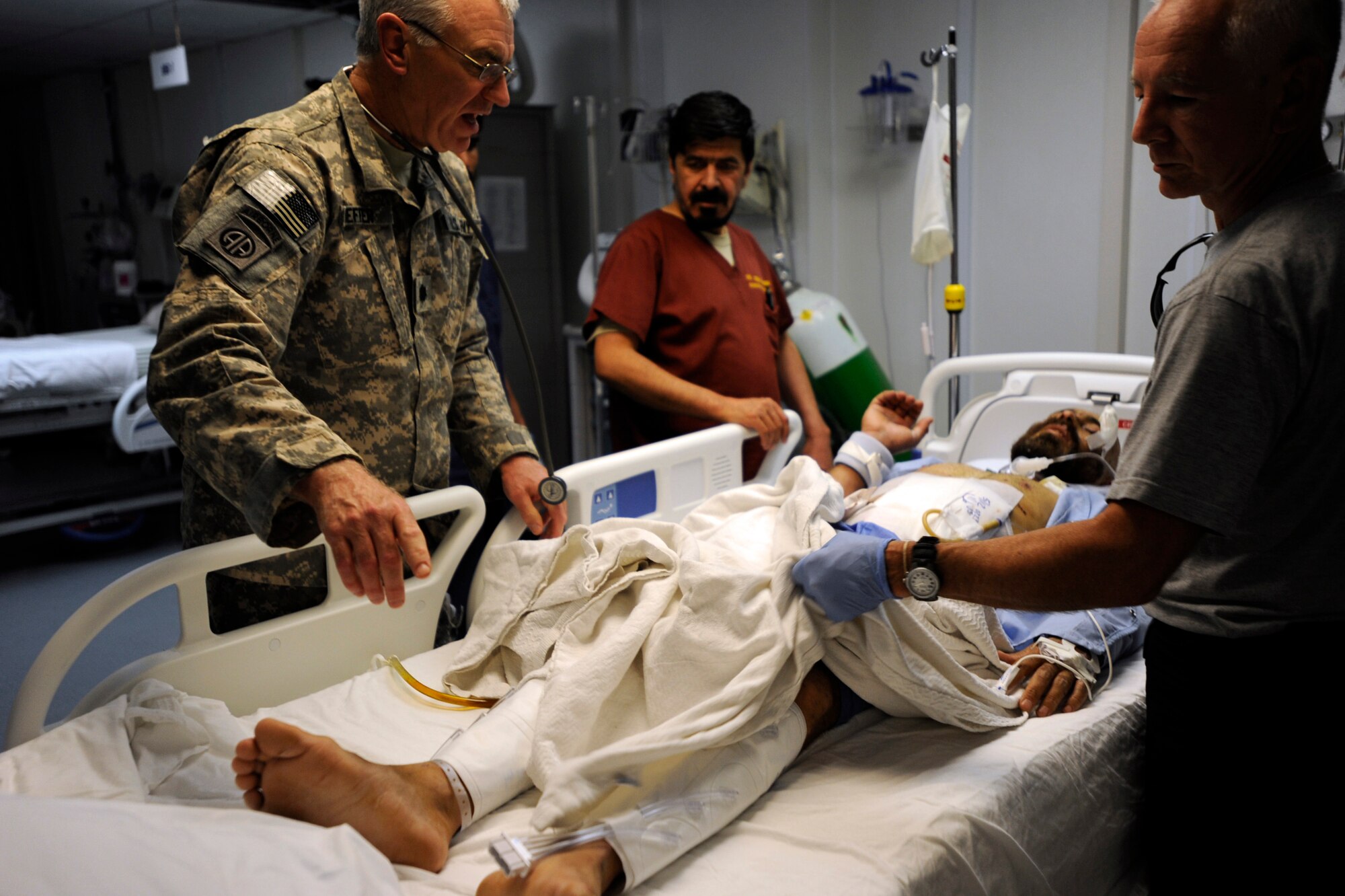 U.S. Army Lt. Col.(Dr.) Bob Kieffer, left, a vascular surgeon, and U.S. Amry Lt. Col (Dr.) Davis Williams, an internal medicine doctor,  both assigned to the 452nd Combat Support Hospital, asses an Afghan patient May 12, 2010, at Forward Operating Base Salerno, Afghanistan. (U.S. Air Force photo/Staff Sgt. Manuel J. Martinez/released) 