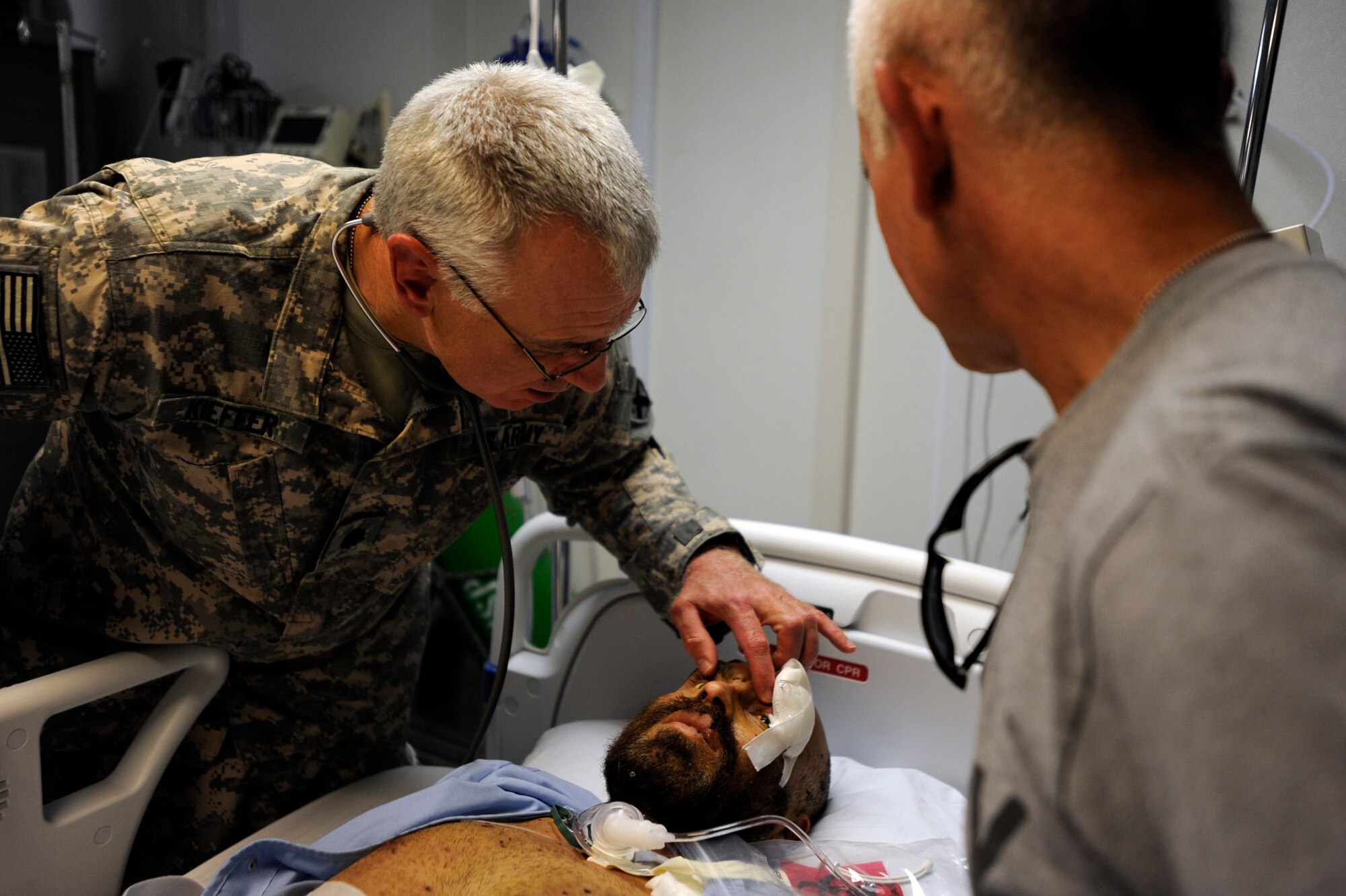 Army Lt. Col.(Dr.) Bob Kieffer, left, a vascular surgeon assigned to the 452nd Combat Support Hospital, checks the vitals of an Afghan patient arriving at the Salerno Hospital, as Amry Lt. Col (Dr.) Davis Williams, an internal-medicine doctor also assigned to the 452nd CSH, assists May 12, 2010, at Forward Operating Base Salerno, Afghanistan. (U.S. Air Force photo/Staff Sgt. Manuel J. Martinez/released)  