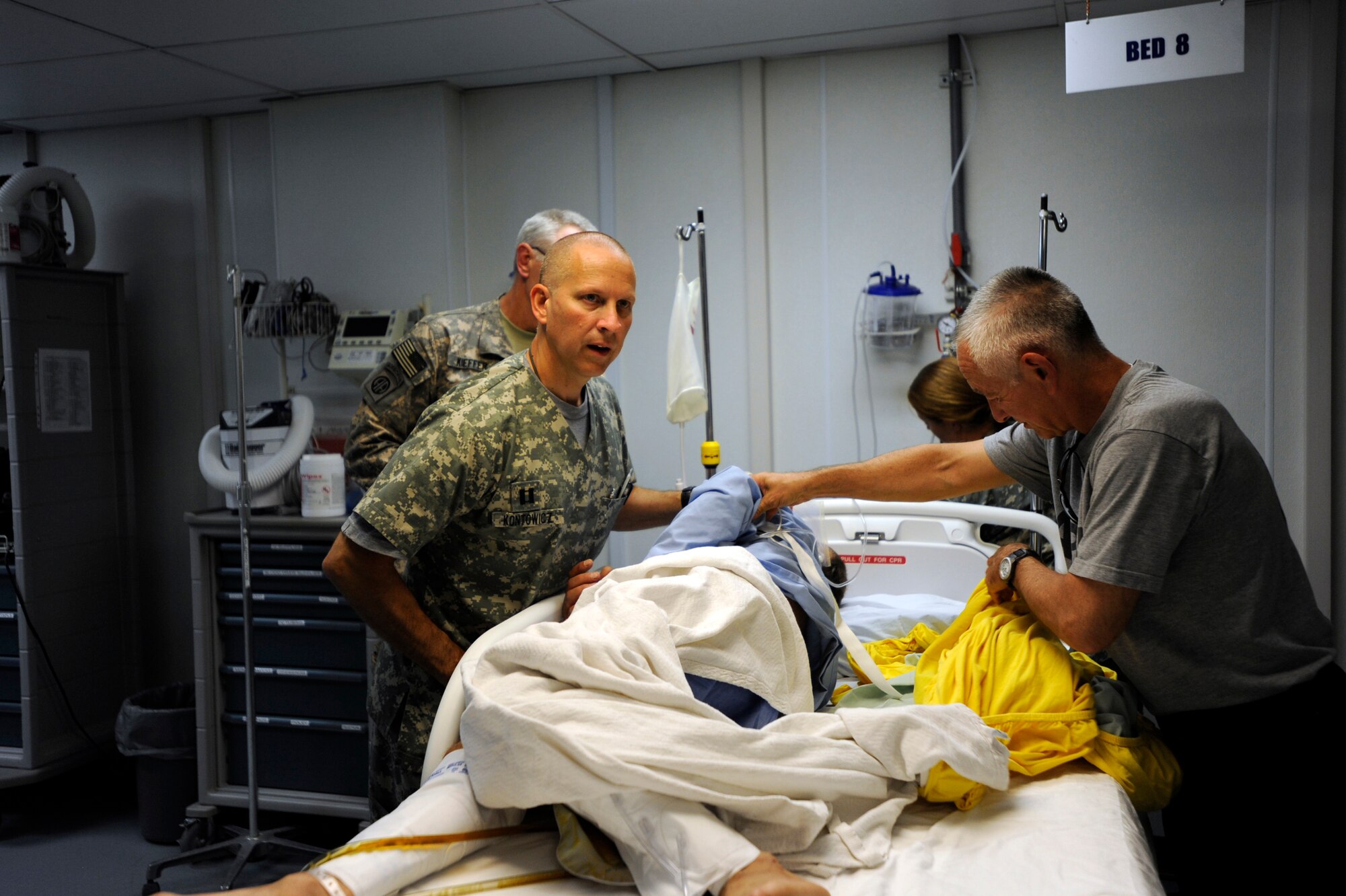 U.S. Army Capt. Andrew Kontowiczm, left, a nurse assigned to the 452nd Combat Support Hospital, speaks with U.S. Air Force Capt. Cassie Ayott, a flight-nurse advisor assigned to the 438th Air Expeditionary Advisor Squadron, about the condition of a patient during his medical evacuation May 12, 2010, at Forward Operating Base Salerno Hospital, Afghanistan. (U.S. Air Force photo/Staff Sgt. Manuel J. Martinez/released) 