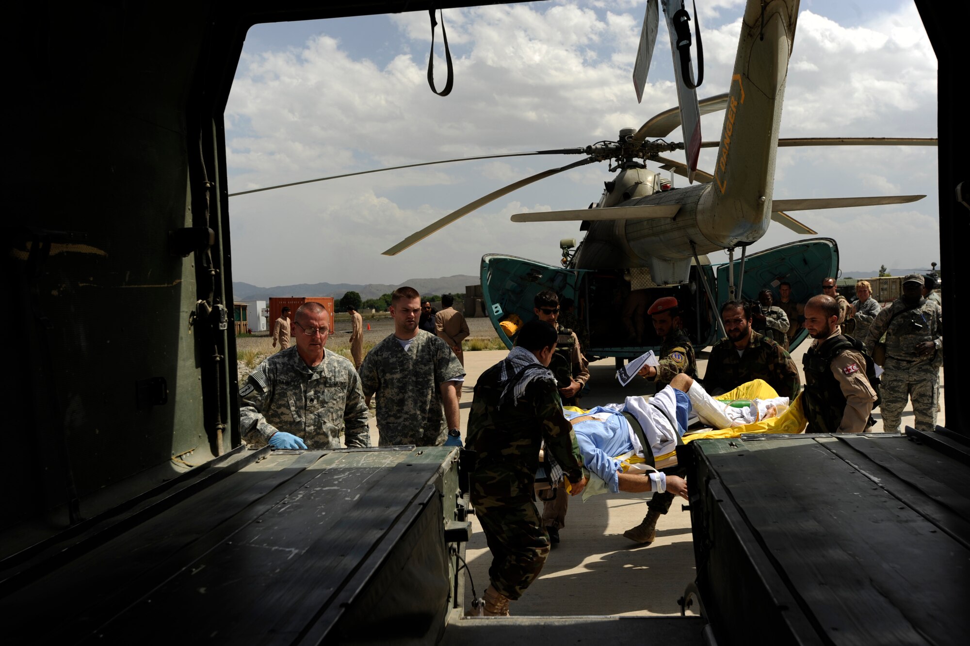 Afghan National Army Air Corps soldiers and flight medics carry a patient to an ambulance for transport to the Salerno Hospital, May 12, 2010, at Forward Operating Base Salerno, Afghanistan. The Salerno Hospital receives medical-evacuation patients, Afghan National Army soldiers, Afghan National Army Air Corps Soldiers, as well as local nationals and helps them get back their units and families after receiving higher medical care at other hospitals throughout Afghanistan. (U.S. Air Force photo/Staff Sgt. Manuel J. Martinez/released) 