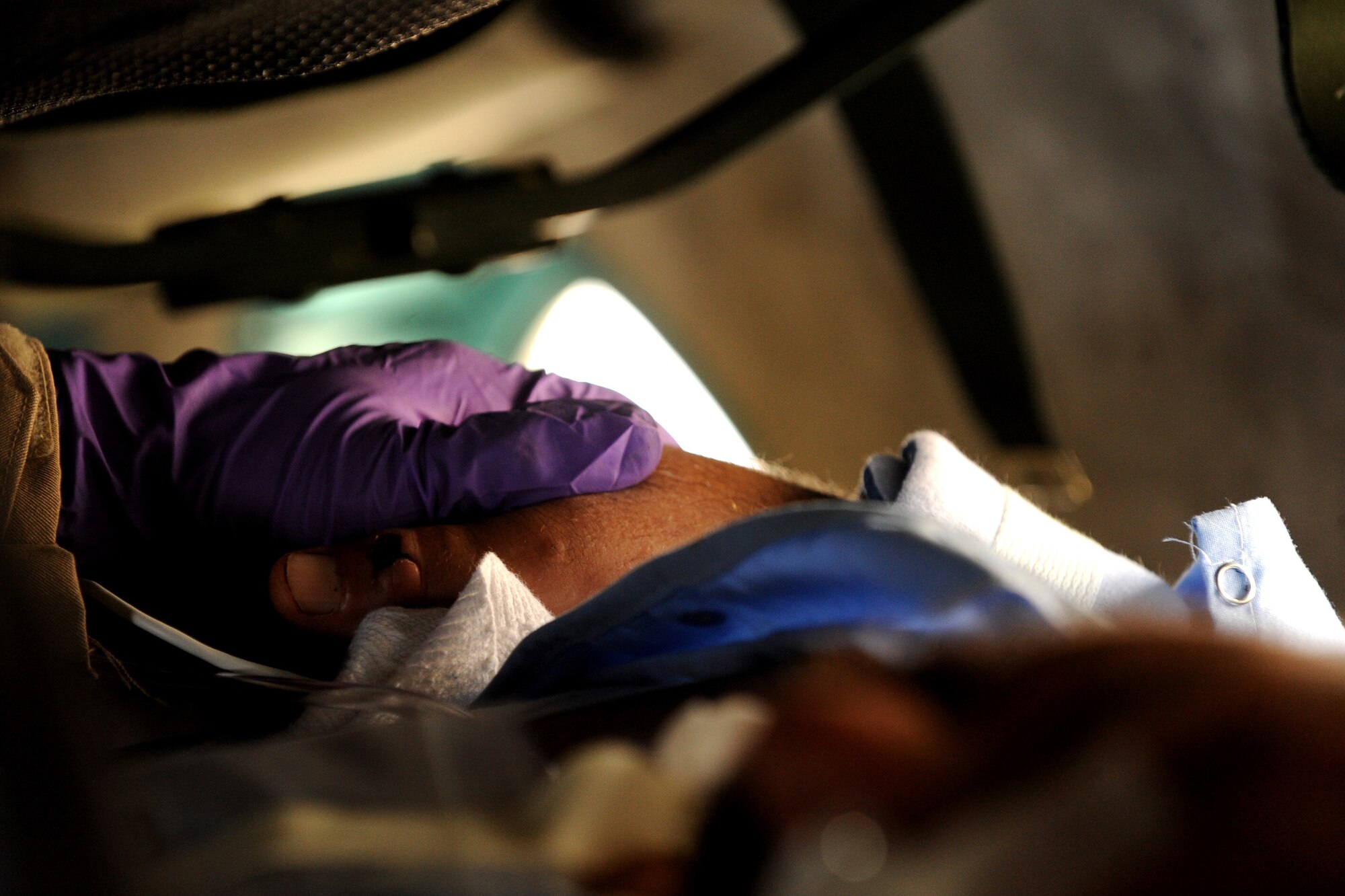 Sergeant Malik Hamet, an Afghan National Army Air Corps flight medic, checks on patients aboard an Mi-17 helicopter May 12, 2010, over Afghanistan. (U.S. Air Force photo/Staff Sgt. Manuel J. Martinez/released) 
