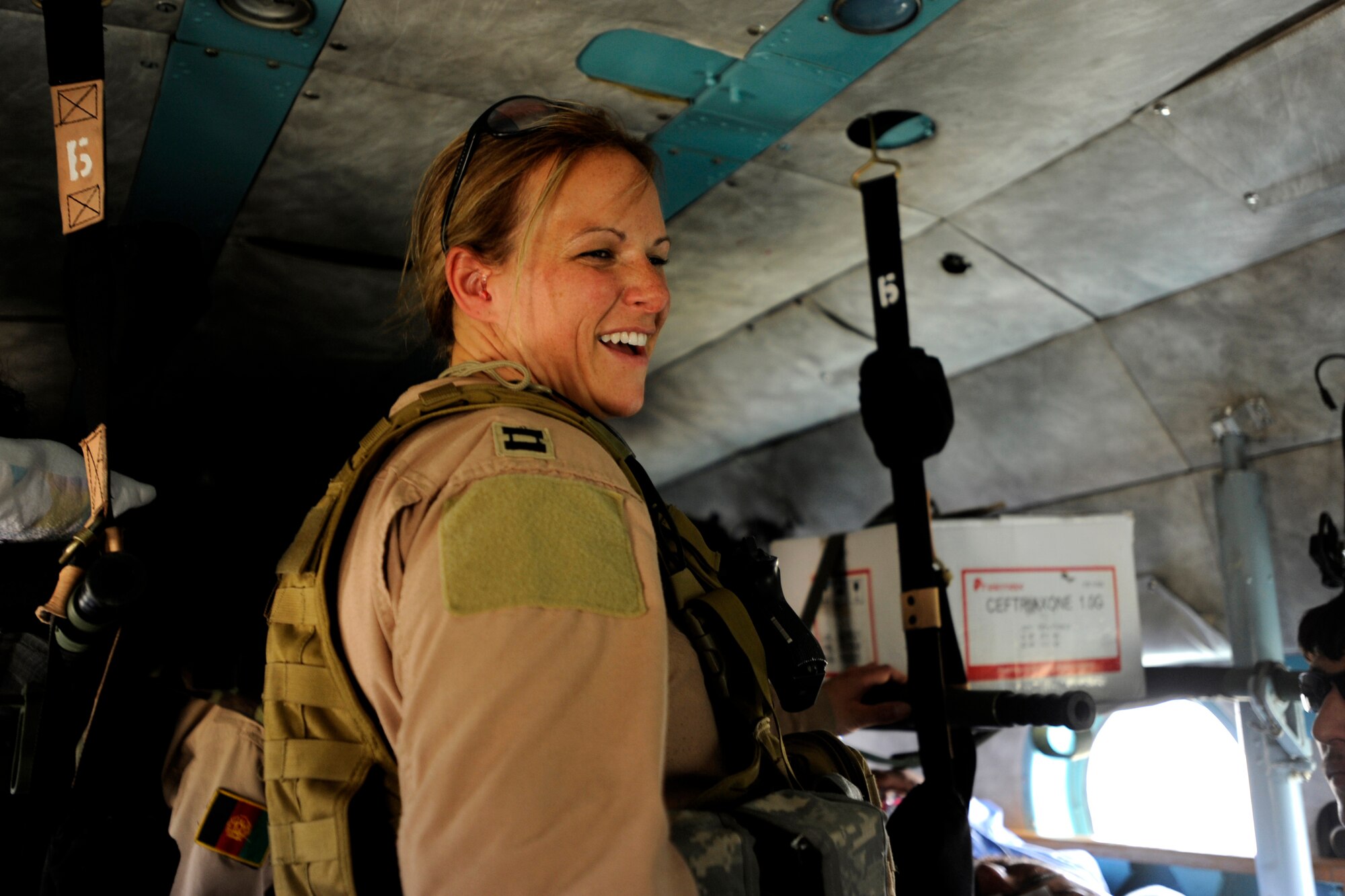 U.S. Air Force Capt. Cassie Ayott, a flight-nurse advisor assigned to the 438th Air Expeditionary Advisor Squadron, takes a moment from patient care during a flight on an Mi-17, May 12, 2010, over Afghanistan. ?Since our first mission in February, our Afghan medics have made significant strides," said Capt. Ayott, deployed from the 139th Aeromedical Squadron at Stratton Air National Guard Base, N.Y. ?The Afghans are moving to the forefront of this mission and are on target toward our goal of them conducting  this mission without our help.?(U.S. Air Force photo/Staff Sgt. Manuel J. Martinez/released) 