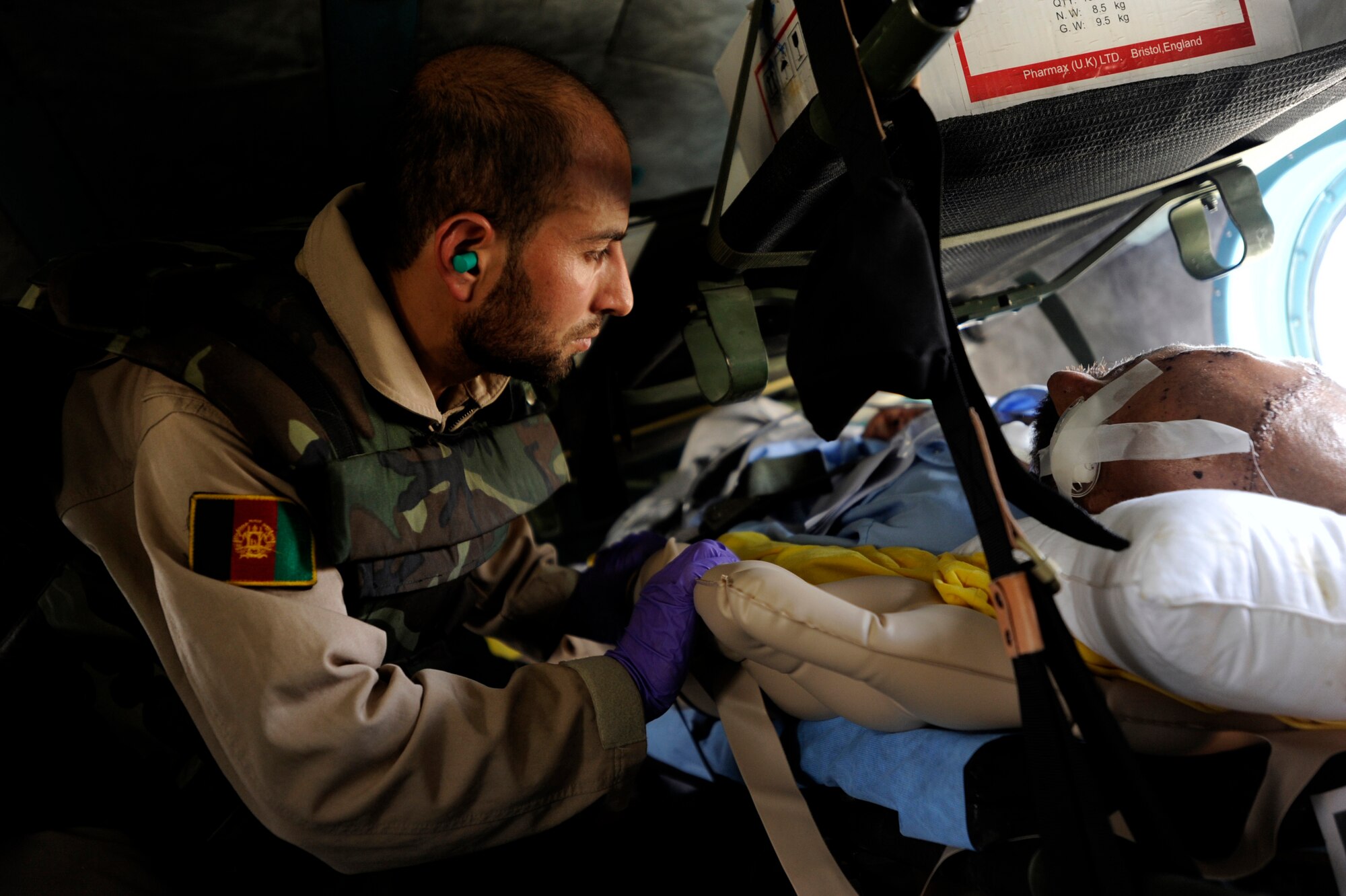Sergeant Malik Hamet, an Afghan National Army Air Corps flight medic, attends to one of his patients on an Mi-17 helicopter bound for a medical facility May 12, 2010, in Afghanistan. Afghan medics are trained on patient care, movement, safety, sanitization and movement coordination. (U.S. Air Force photo/Staff Sgt. Manuel J. Martinez/released) 
