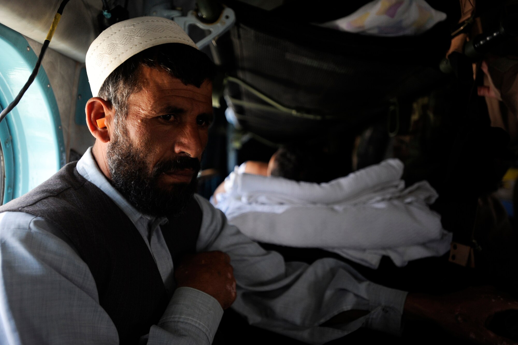An Afghan father stays with his son as he is transported aboard an Mi-17 helicopter to another medical facility May 12, 2010, after being treated and discharged from the Craig Joint Theater Hospital at Bagram Airfield, Afghanistan. (U.S. Air Force photo/Staff Sgt. Manuel J. Martinez/released) 