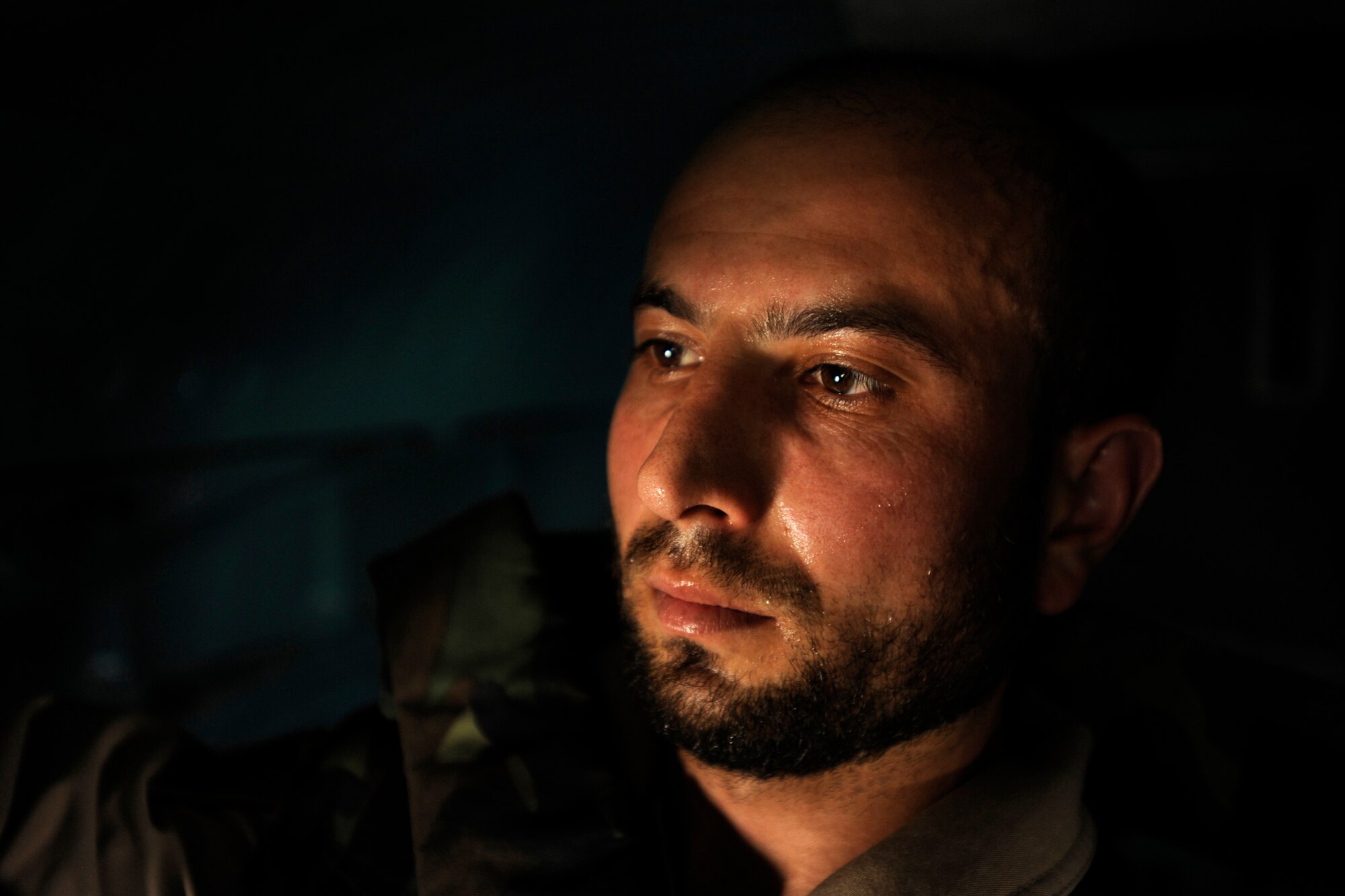 Sergeant Malik Hamet, an Afghan National Army Air Corps flight medic, looks out a window on an Mi-17 helicopter while en-route to pick-up patients May 12, 2010, at the Craig Joint Theater Hospital at Bagram Airfield, Afghanistan. ?This mission really makes me proud,? Sergeant Hamet said. ?I have learned so much about this mission and I get to help my people every day. It is nice to put a smile on someone?s face and contribute to the security of Afghanistan.? (U.S. Air Force photo/Staff Sgt. Manuel J. Martinez/released) 
