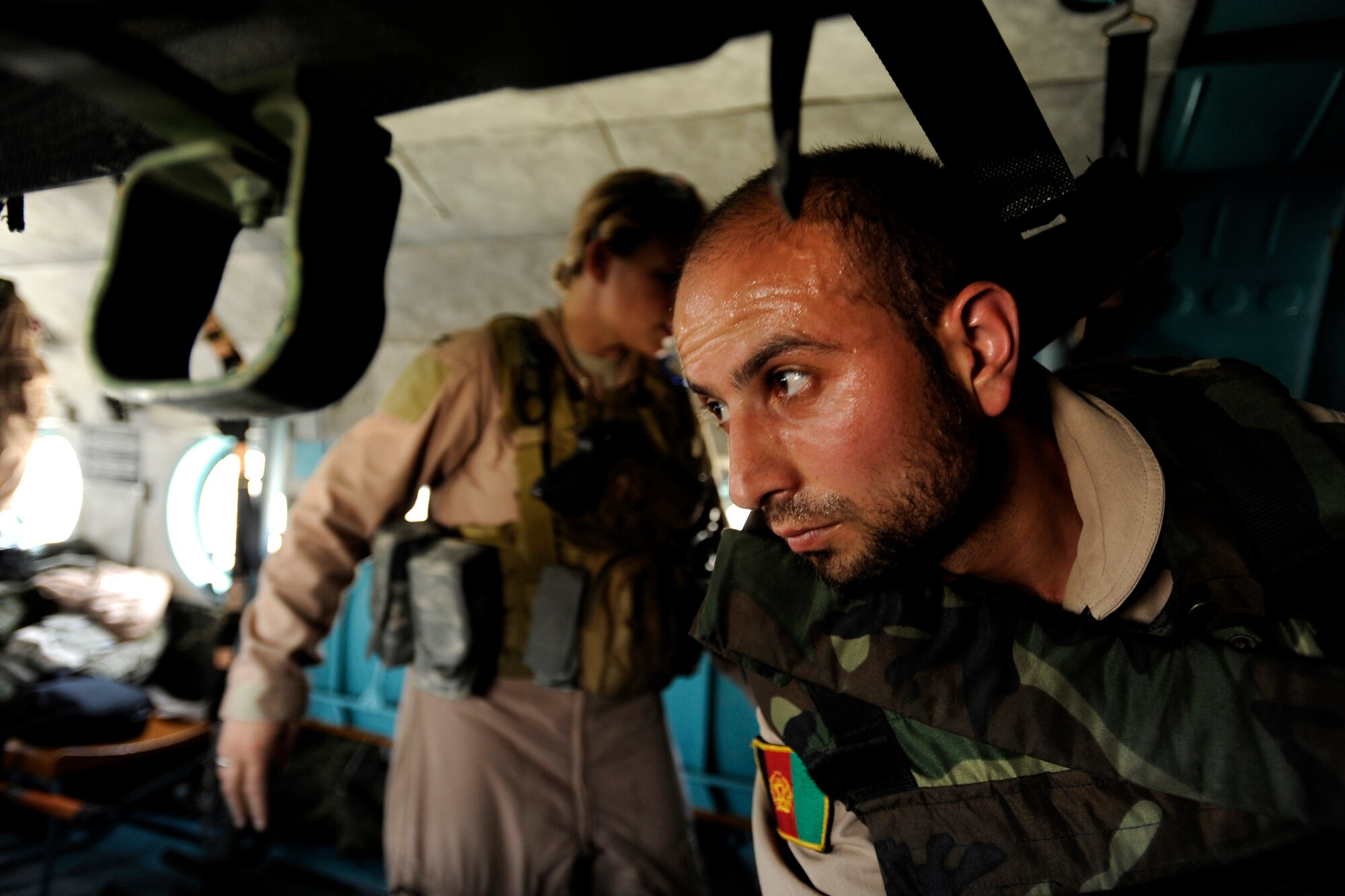Sergeant Malik Hamet, an Afghan National Army Air Corps flight medic, and U.S. Air Force Capt. Cassie Ayott, a flight-nurse advisor assigned to the 438th Air Expeditionary Advisor Squadron, set-up stretchers and medical equipment for patients being transported during a reverse medevac mission aboard an Mi-17 helicopter May 12, 2010, at Kabul International Airport, Afghanistan. (U.S. Air Force photo/Staff Sgt. Manuel J. Martinez/released) 
