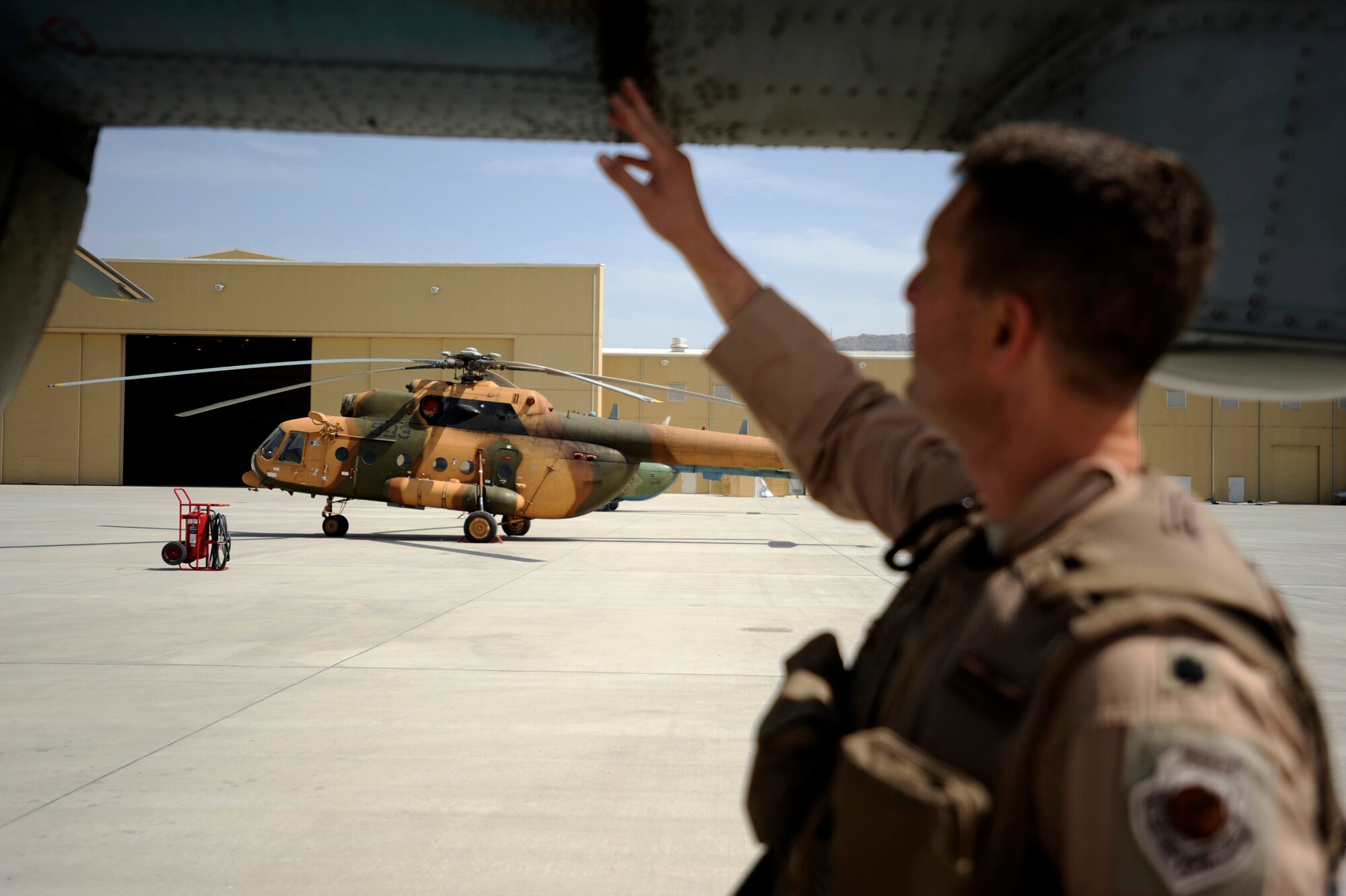 U.S. Air Force Lt. Col. Greg Roberts, commander of 438th Air Expeditionary Advisor Squadron and an Mi-17 pilot, performs a walk-around inspection of an Mi-17 prior to take-off for a reverse medical evacuation mission May 12, 2010, at Kabul International Airport, Afghanistan. (U.S. Air Force photo/Staff Sgt. Manuel J. Martinez/released) 