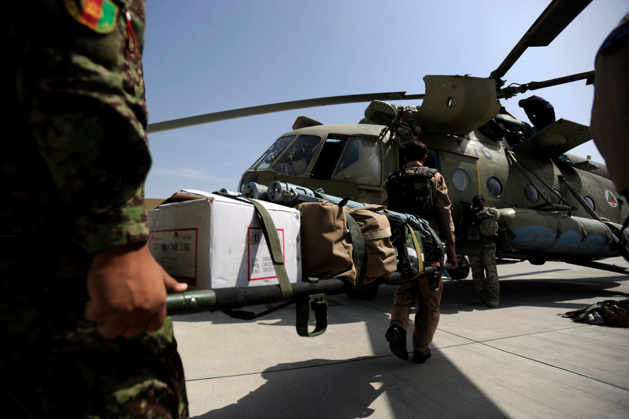 Sergeant Abdul Salaam, front, an Afghan National Army Air Corps flight medic, and an ANAAC soldier load medical equipment on an Mi-17 helicopter to transport patients May 12, 2010, at Kabul International Airport, Afghanistan. (U.S. Air Force photo/Staff Sgt. Manuel J. Martinez/released) 