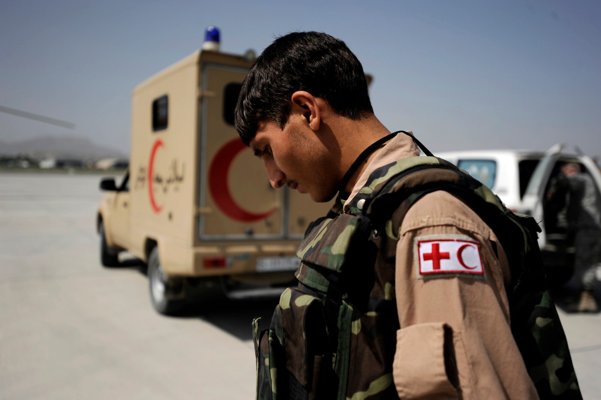 Sergeant Abdul Salaam, an Afghan National Army Air Corps flight medic, walks to an ambulance to download medical equipment needed aboard an Mi-17, for transporting patients prior to a reverse medical evacuation mission May 12, 2010, at Kabul International Airport, Afghanistan. The purpose of reverse medical evacuations is to get Afghan patients from higher medical care, back to their units or closer to home. (U.S. Air Force photo/Staff Sgt. Manuel J. Martinez/released) 