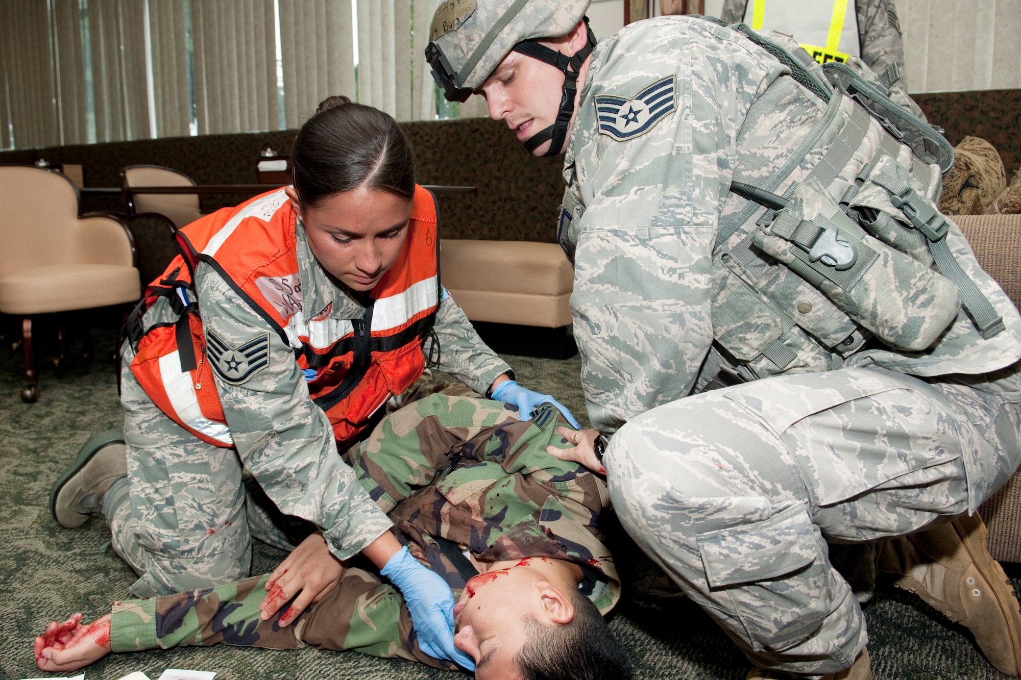 YOKOTA AIR BASE, Japan -- Staff Sgt. Carleen Wallance (left), 374th Medical Group, and Staff Sgt. Zachary Burtt, 374th Security Forces Squadron, check a victim's vital signs here May 24 during a simulated mass casualty event during an operational readiness exercise. Yokota is conducting an exercise through May 27 to maintain operational readiness. (U.S. Air Force photo/Osakabe Yasuo)