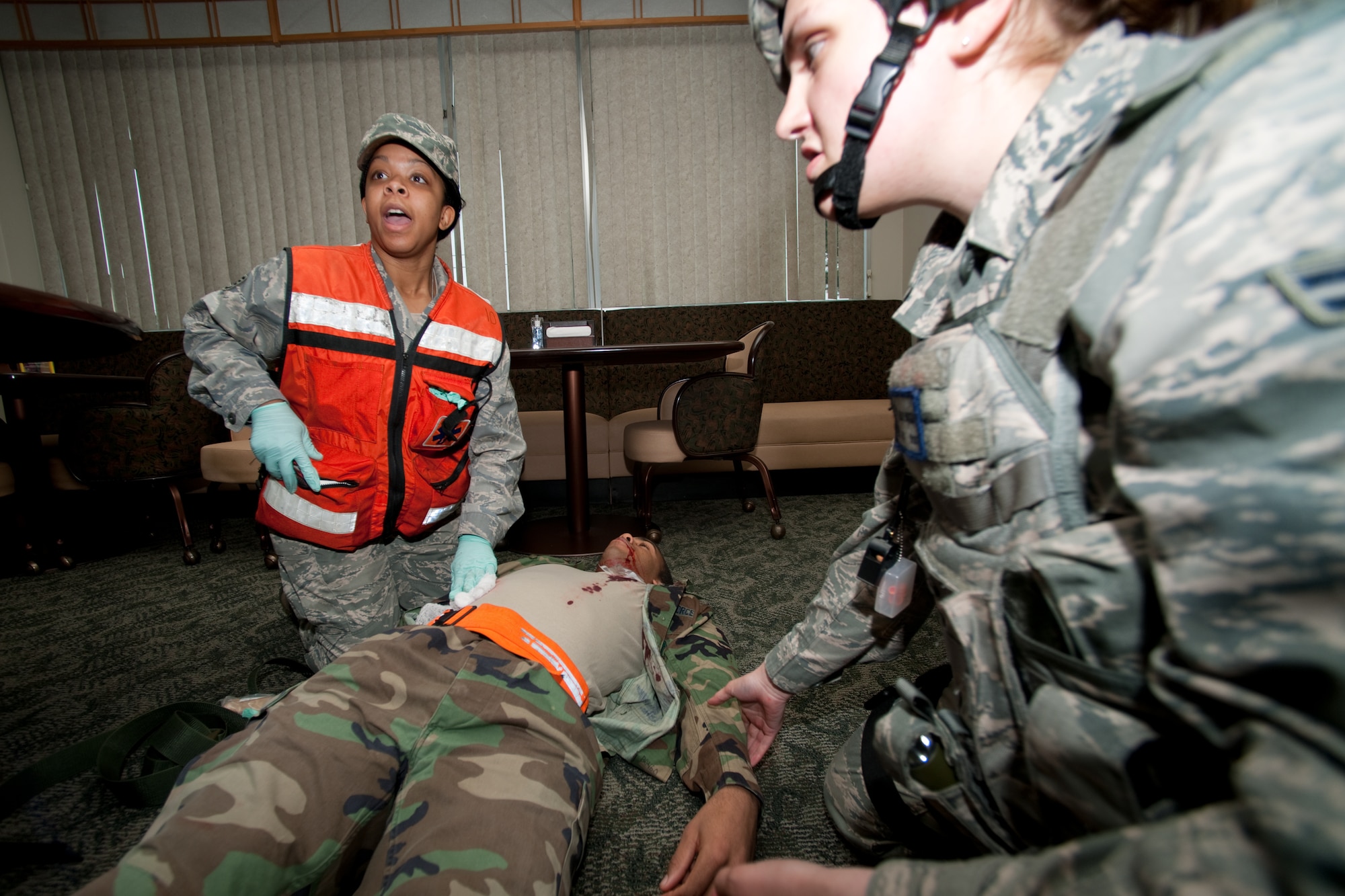 YOKOTA AIR BASE, Japan -- Staff Sgt. Alicia Tucker (left), 374th Surgical Operations Squadron, calls for a stretcher here May 24 during an simulated mass casualty event during an operational readiness exercise. Yokota is conducting an exercise through May 27 to maintain operational readiness. (U.S. Air Force photo/Osakabe Yasuo)