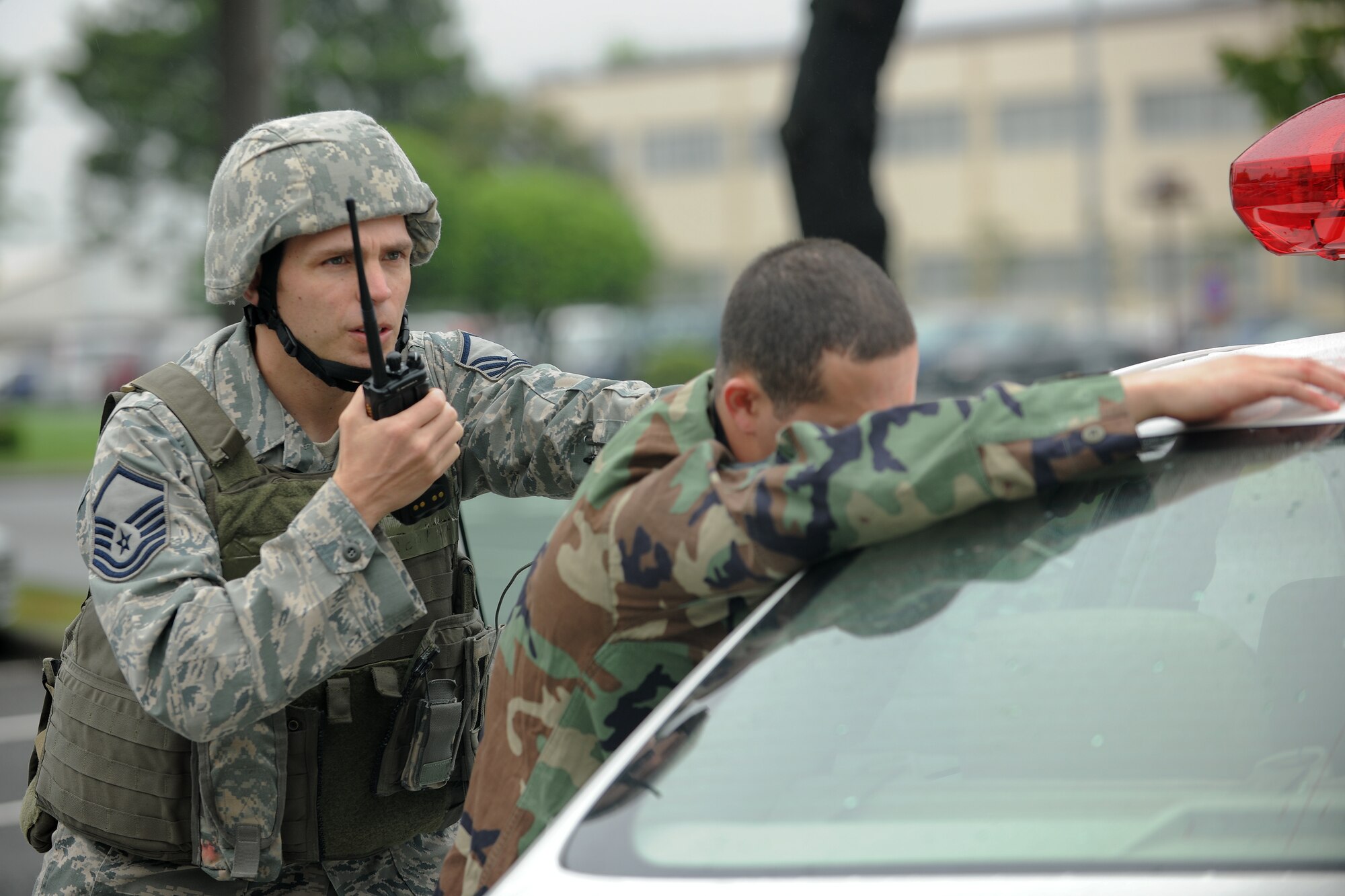 YOKOTA AIR BASE, Japan -- Master Sgt. Brent Paul, 374th Security Forces Squadron, calls the Law Enforcement desk after detaining a robber here May 24 during a simulated robbery during an operational readiness exercise. Yokota is conducting an exercise through May 27 to maintain operational readiness. (U.S. Air Force photo/Osakabe Yasuo)