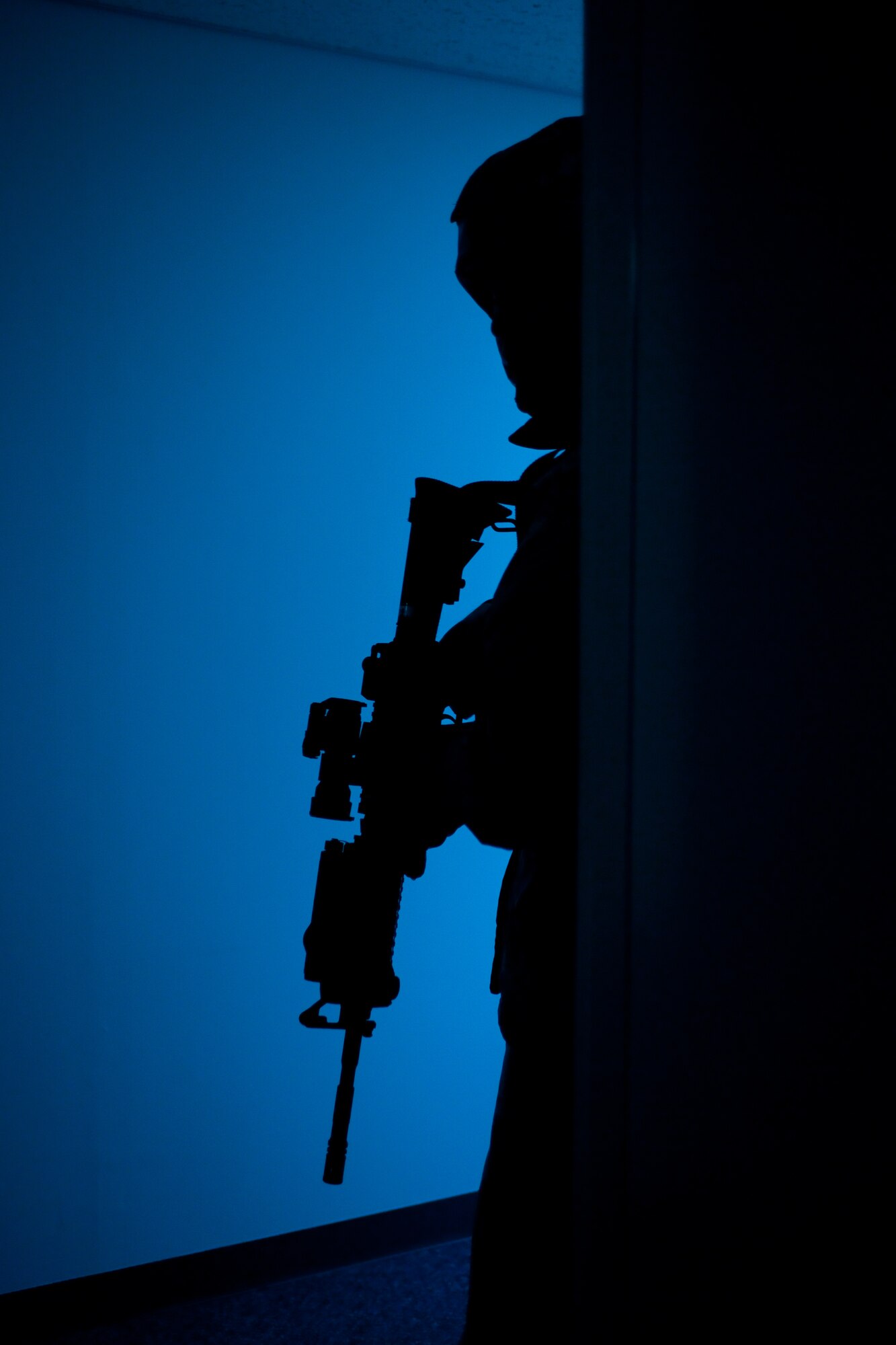 YOKOTA AIR BASE, Japan -- Airman 1st Class Limuel Beltran, 374th Security Forces Squadron, watches his wingman's back during an anti robbery procedure here May 24 during an operational readiness exercise. Yokota is conducting an exercise through May 27 to maintain operational readiness. (U.S. Air Force photo/Osakabe Yasuo)