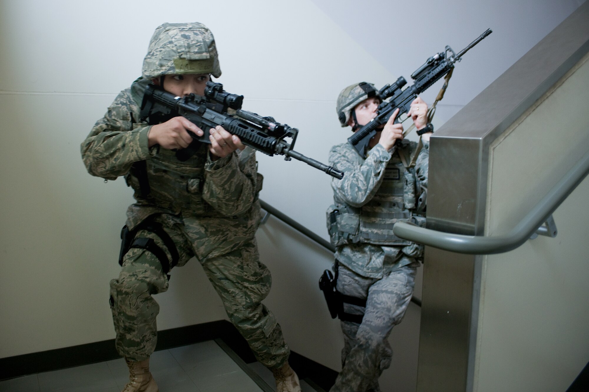 YOKOTA AIR BASE, Japan -- Airman 1st Class Limuel Beltran (left) and Staff Sgt. Zachary Burtt, both from the 374th Security Forces Squadron, survey a robbery site here May 24 during an operational readiness exercise. Yokota is conducting an exercise through May 27 to maintain operational readiness. (U.S. Air Force photo/Osakabe Yasuo)