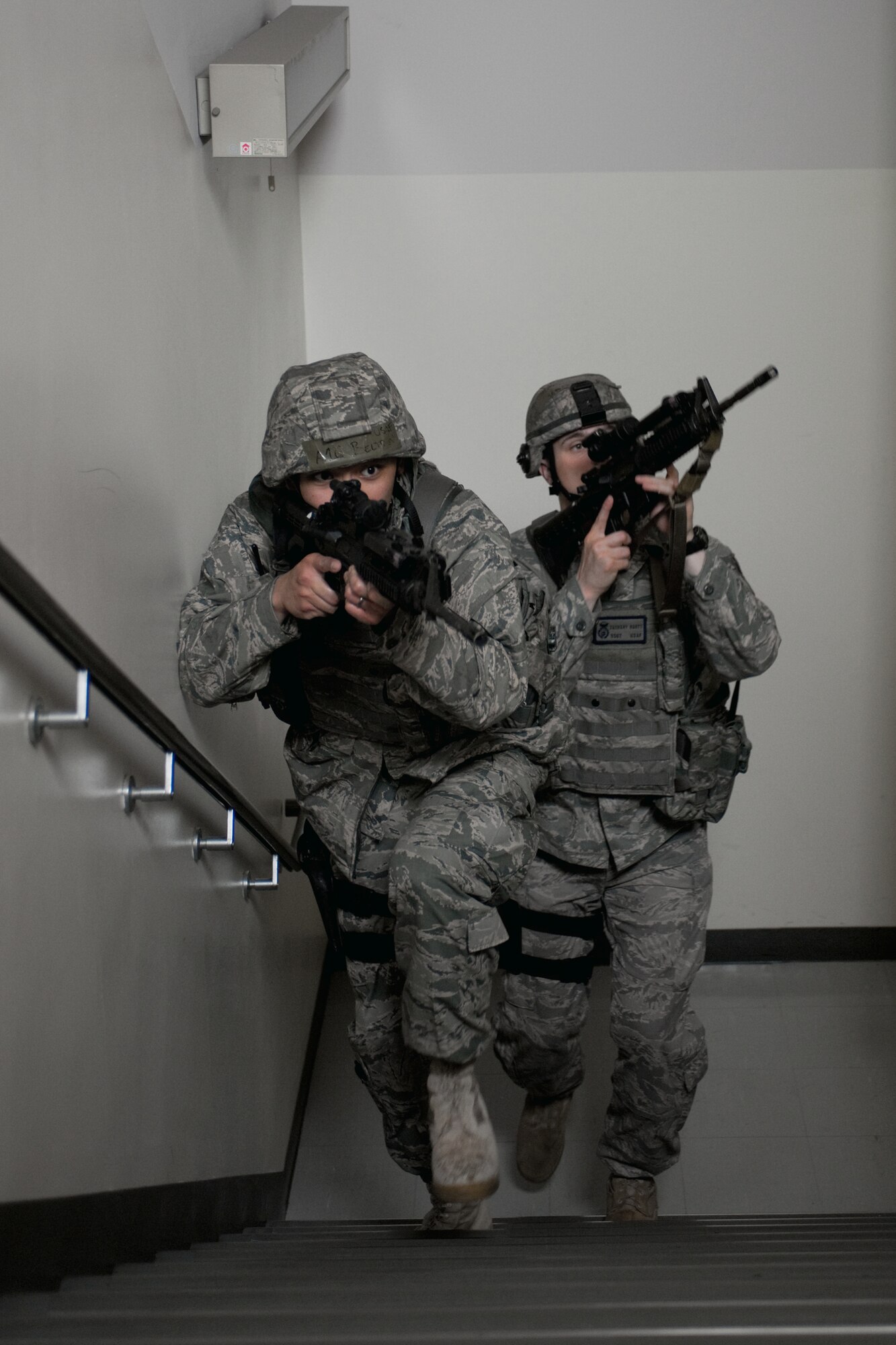YOKOTA AIR BASE, Japan -- Airman 1st Class Limuel Beltran (front) and Staff Sgt. Zachary Burtt, both from the 374th Security Forces Squadron, survey a  building during a robbery here May 24 during an operational readiness exercise. Yokota is conducting an exercise through May 27 to maintain operational readiness. (U.S. Air Force photo/Osakabe Yasuo)