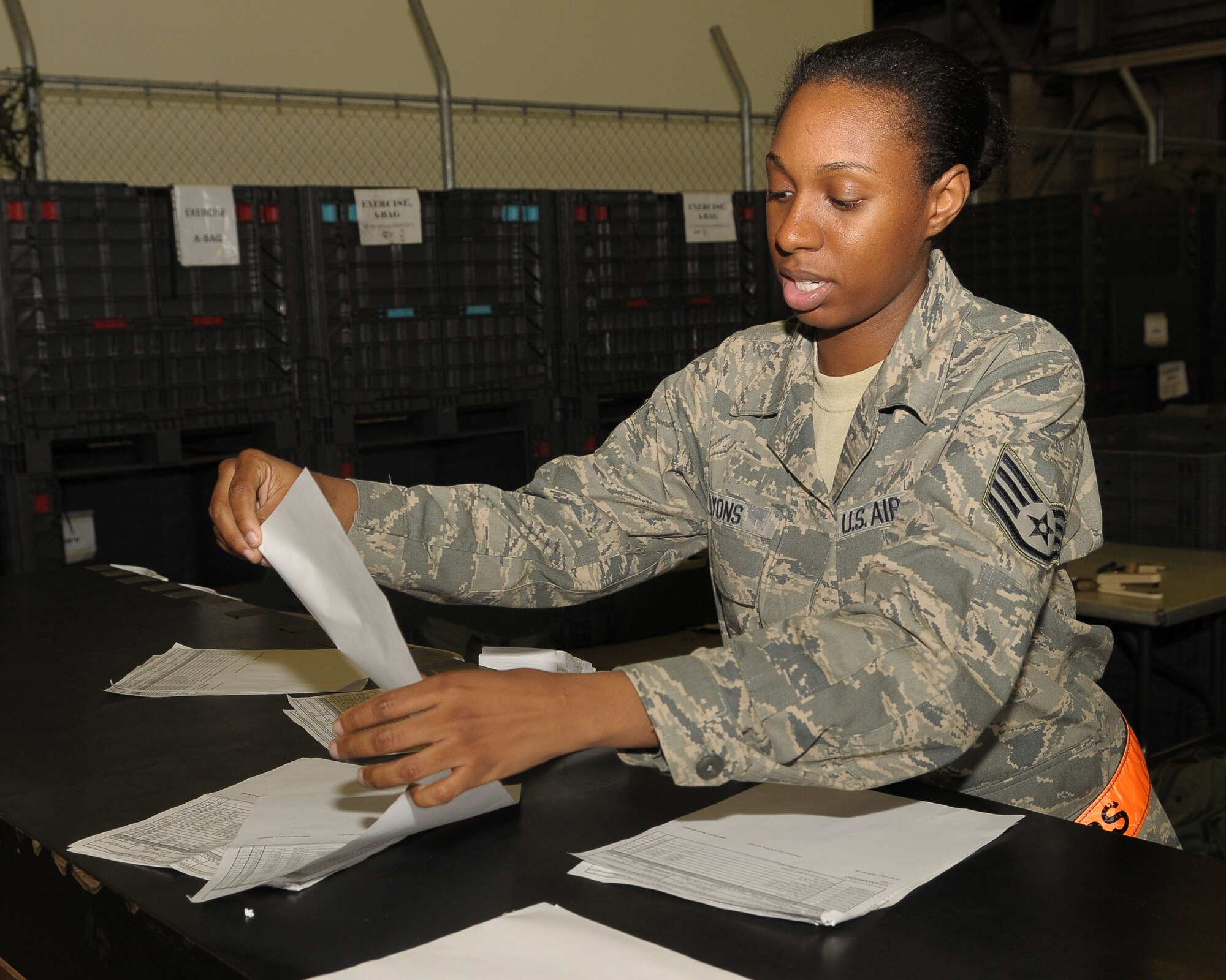 YOKOTA AIR BASE, Japan -- Staff Sgt. Laquita Lyons, 374th Logistics Readiness Squadron individual protective equipment (IPE) supervisor, organizes hand receipts for IPE bags May 24 during an operational readiness exercise. Yokota is conducting an exercise through May 27 to maintain operational readiness. (U.S. Air Force photo/Airman 1st Class Sean Martin)