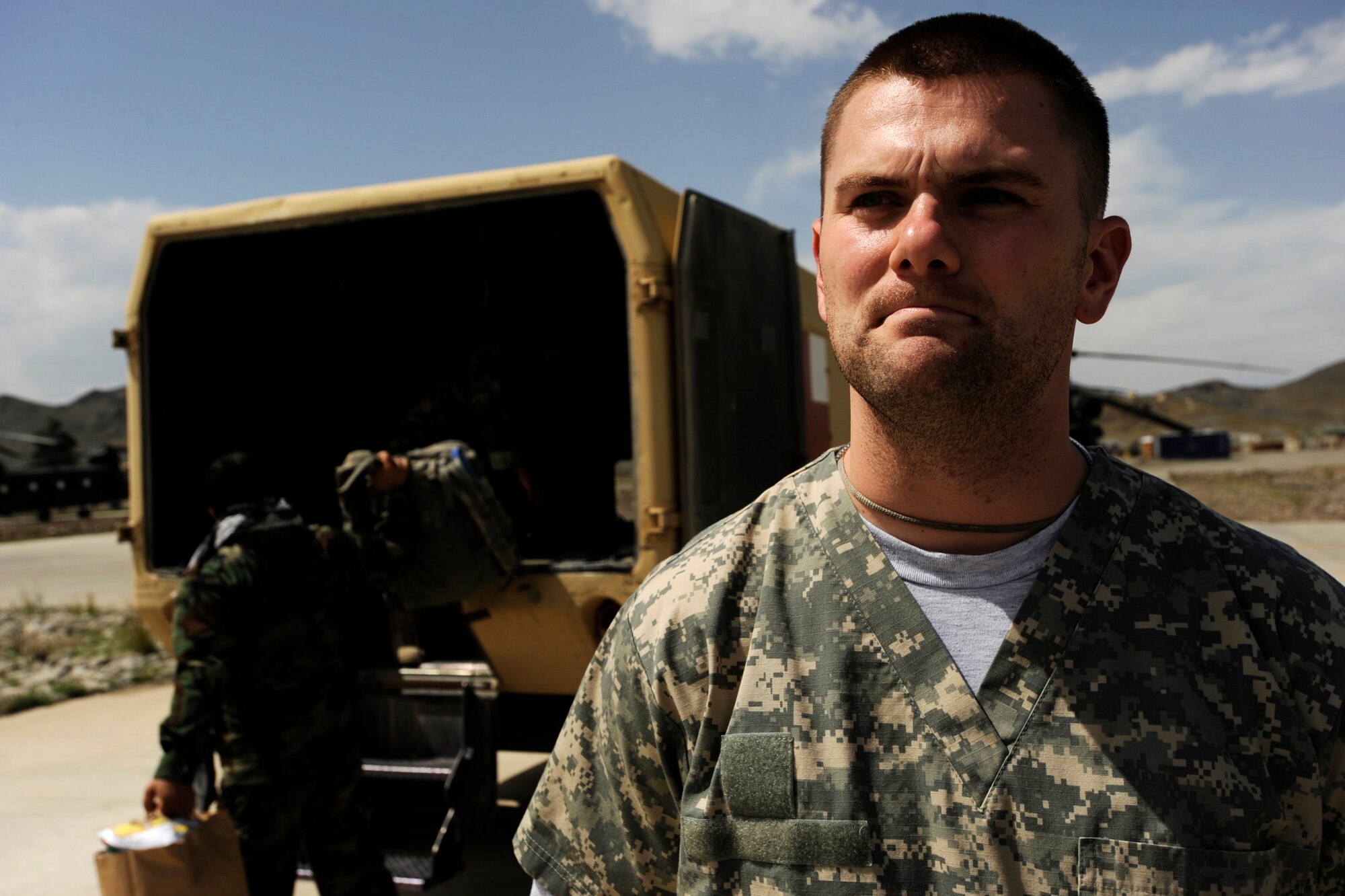Tech. Sgt. William Haley, an emergency-medical technician assigned to the 452nd Combat Support Hospital, takes a moment while Afghan Army Air Corp medics prepare patients to be unloaded from an Mi-17 and placed in an ambulance to transport them to the Salerno Hospital May 12, 2010, at Forward Operating Base Salerno, Afghanistan. ?This has been a wonderful place to learn, grow and develop my skills as an emergency medical technician,? Sergeant Haley said. ?This is one of the most dedicated, motivated and caring teams I have ever worked with and I am proud to be a part of this mission.? (U.S. Air Force photo/Staff Sgt. Manuel J. Martinez/released) 

