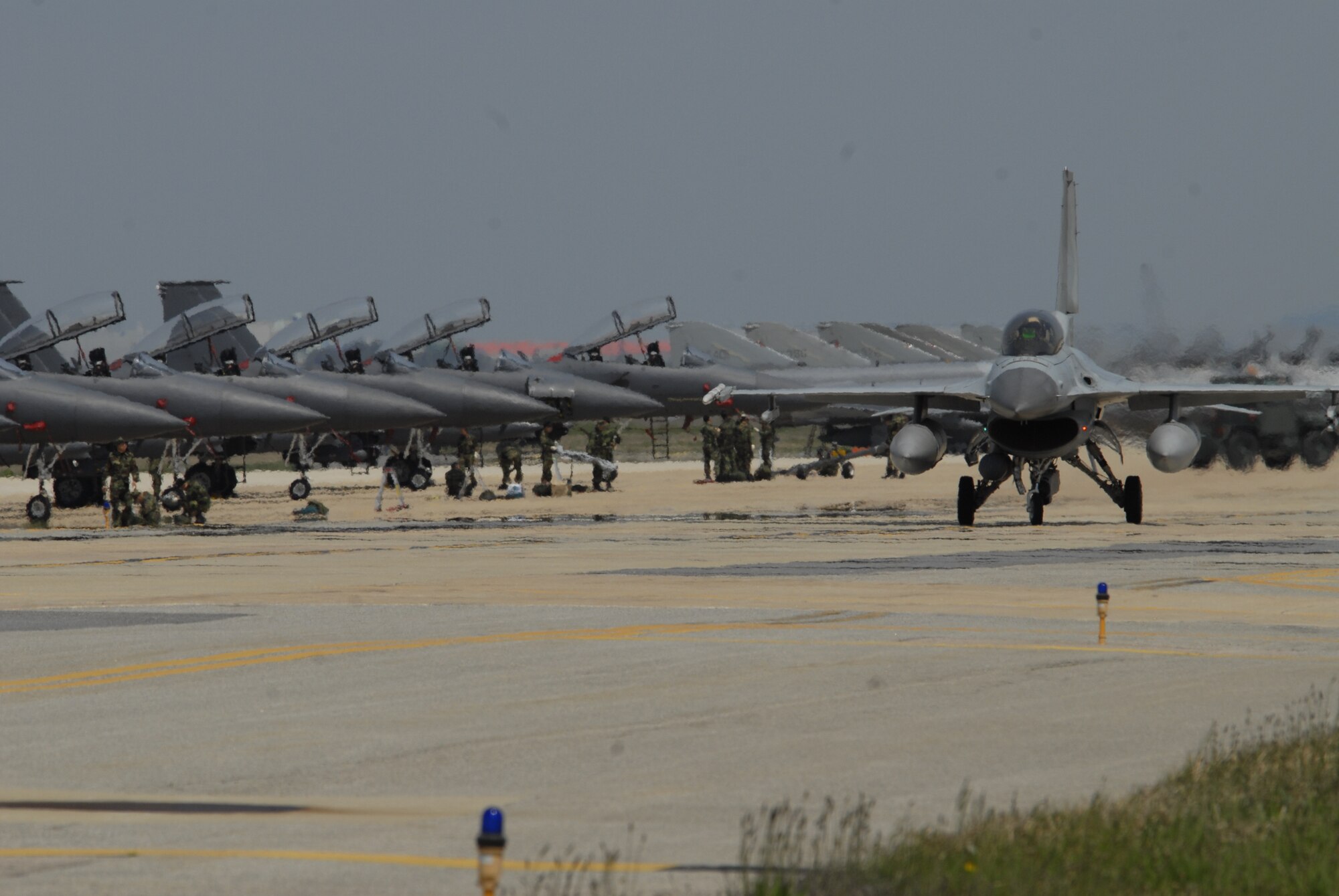 KUNSAN AIR BASE, Republic of Korea--8th Fighter Wing F-16 Fighting Falcons line up on the runway during an exercise the week prior to the surge operations. The Wolf Pack tested its pilots, maintainers and supporting personnel with three weeks of flying operations. As a result the Wolf Pack met its goals of generating aircrafts in the required amount of time and is ready to fly, fight and win. (U.S. Air Force photo/Staff Sgt. Darnell Cannady)