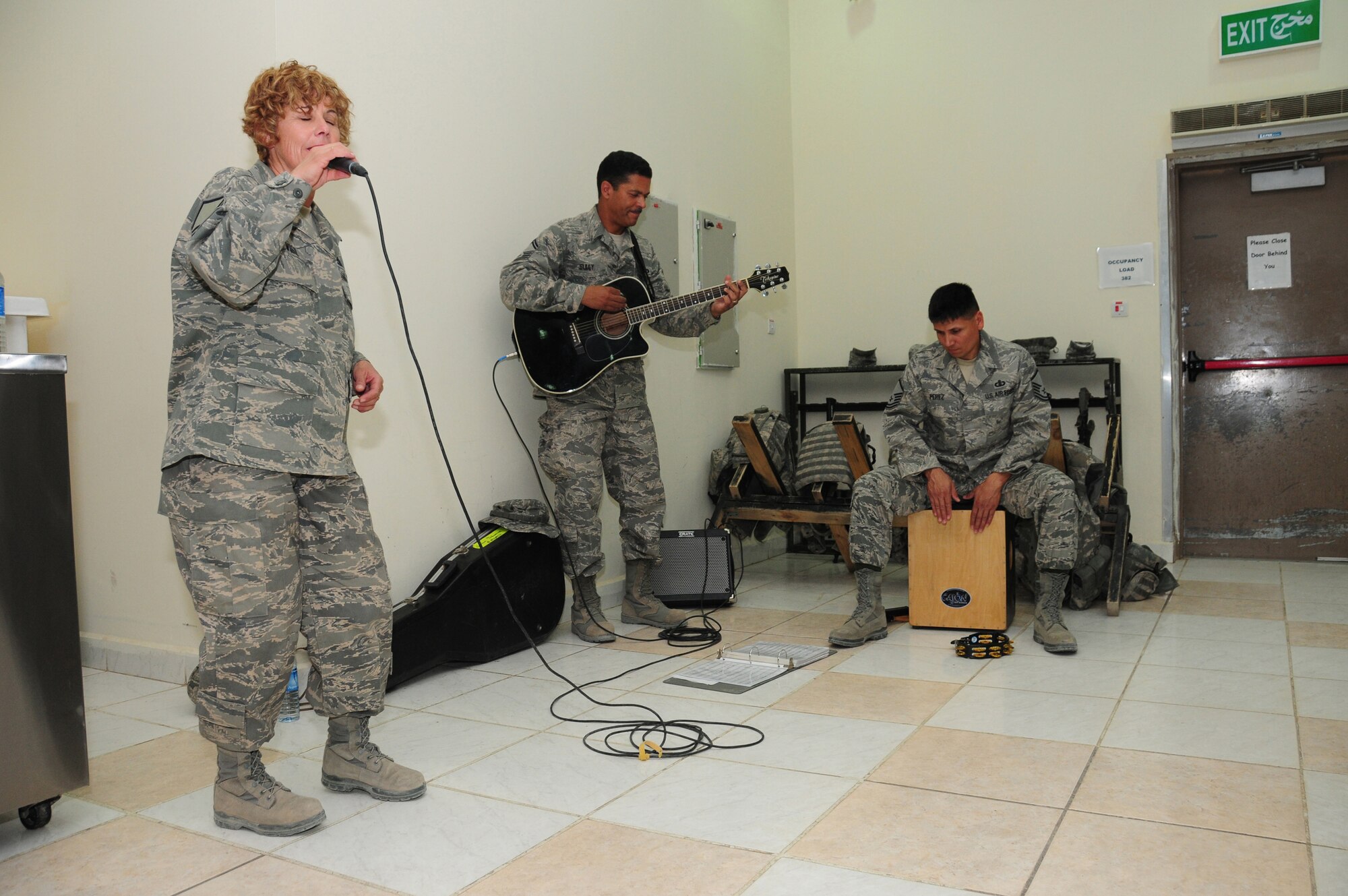 From left, U.S. Air Forces Central Command band "Vector" members, Master Sgt. Verlie Vigil, vocalist, Senior Master Sgt. Ballard Sully, guitarist, and Master Sgt. Paul Perez, percussionist, perform for the men and women of the 386th Expeditionary Security Forces Squadron here at an air base in Southwest Asia May 21, 2010. Formed in 2008, "Vector" is a seamless combination of brass, vocals, guitar and percussion.  (U.S. Air Force photo by Staff Sgt. Lakisha A. Croley/Released)
